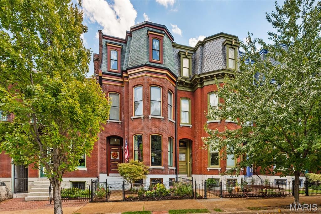This stunning historic **Ripple Row** home combines timeless character with beautifully updated living spaces across **four levels**. Offering 4 bedrooms, 2 full baths, 2 half baths, a partially finished walk-out lower level with bar, half bath, covered patio, and gated off-street parking  This home has incredible space inside and out.  The main level showcases a stunning living room with large bay window, formal dining and a sharp custom kitchen featuring maple cabinetry, granite countertops, coffee bar, stainless steel appliances, slate backsplash, ceramic flooring, and an impressive **7-foot granite center island**. Crown molding throughout and two covered porches add to the home's historic charm.  The second level offers 3 spacious bedrooms, a full bath, beautiful wood floors, and abundant closet space. The entire third floor is dedicated to a **private primary suite** with separate HVAC, insulated windows, walk-in closet, laundry, coffee bar, and a luxurious bath featuring double vanities, heated floors, separate shower, and soaking tub.  The partially finished walk-out lower level adds even more entertaining space with a bar area and half bath. Laundry on third floor and lower level backup.  Step outside to a private backyard with gated off-street parking plus room for a future carport or garage.  Light, bright, and beautifully maintained throughout—this home offers four incredible levels of living in the heart of historic Soulard.** Walk to restaurants, bars, neighborhood parks—including the French Dog Park—and enjoy being just one block from Anheuser-Busch. Convenient access to major highways puts Downtown and many of St. Louis' favorite attractions within easy reach.  updates: main roof (2/3 of the roof), central heating, , mini split on third floor, & water heater  Front bay windows  See disclosures for details.