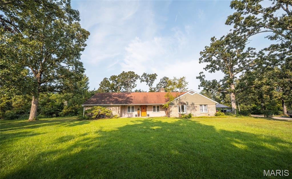 Welcome to an extraordinary countryside retreat where timeless charm meets modern comfort on nearly 15 breathtaking acres. Offering 7 bedrooms and 4 bathrooms, this one-of-a-kind property has been almost completely remodeled, creating the perfect blend of updated living and historic character while leaving just enough opportunity for the next owner to add their own personal finishing touches.

From the moment you arrive, you'll be captivated by the property's storybook setting. Wander among mature fruit trees, cast a line into the pond, or unwind beside the peaceful waterfall as nature provides the perfect backdrop for everyday life. The vintage tennis court, chicken coop, and historic hitching post add a sense of nostalgia and endless possibilities for recreation, hobby farming, or entertaining. Enjoy parking under the new carport & the home is getting a new roof & gutters installed soon!

Inside, thoughtful updates make this home ready for its next chapter, including a new HVAC system, new flooring, kitchen & appliances. Cozy evenings are made even better around the inviting fireplace, while the dedicated home theater creates the perfect space for movie nights, game days, and gathering with family and friends.

With 7 bedrooms (2 having built-in bookcases instead of closets), there's room for everyone, whether you're hosting guests, accommodating a large family, or creating dedicated office and hobby spaces. If you're searching for a private family estate, multi-generational home, hobby farm, or an unforgettable short-term rental opportunity, this remarkable property offers the space, charm, and flexibility to bring your vision to life.

Schedule your private showing today and experience everything this exceptional property has to offer before it's gone!