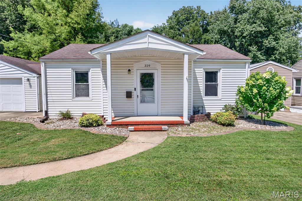 Welcome home to this adorably updated bungalow in the heart of Collinsville!  This charming 2-bedroom, 2-bathroom is conveniently located and features a large, fenced backyard that is perfect for entertaining, pets or play!  Enjoy relaxing on the spacious deck overlooking the huge yard, complete with an additional storage shed for all your outdoor essentials!  Inside, you'll love the "Bright & Cheerful" interior featuring newer windows, paint and updated flooring throughout.  The inviting living room showcases a stylish wood accent wall and flows seamlessly into the kitchen (All Appliances Stay, Refrigerator, Microwave, Gas Stove, Portable Dishwasher and Washer/Dryer!) which provides immediate access through the sliding door to the deck for ease in outdoor entertainment!  Two Bedrooms and a beautifully renovated full bathroom complete the main level.  The clean, well-maintained walk-out lower level offers even more living space options with recreation/family space, dedicated laundry area, storage, "non-conforming" bathroom and "Bonus" room with closet and barn door offering flexibility for guests, hobbies or home office.  Car enthusiasts and hobbyists will appreciate the OVERSIZED GARAGE with abundant workspace and storage!  This Charming home is conveniently located near shopping, dining, parks and provides easy highway access! Move in Ready!