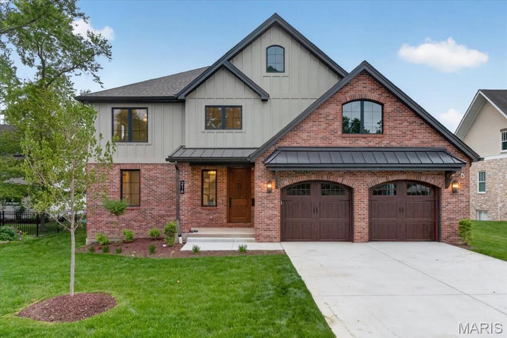Newly completed custom home in the heart of Kirkwood, offering the perfect blend of craftsmanship, comfort, and walkability—just steps from vibrant downtown shops, dining, and parks. This thoughtfully designed home welcomes you with a striking exterior featuring brick and Hardie board-and-batten siding, a solid wood front door, architectural shingles accented with metal roofing, and custom arched insulated garage doors. The oversized garage is fully drywalled and painted, with an optional plan available for a detached third bay .  Inside, you’ll find exceptional attention to detail at every turn. Solid three quarter inch oak hardwood floors span the main level and second-floor hallway, complemented by extensive custom millwork and an open wood staircase with rich wood treads connecting all levels. A spacious mudroom with built-in lockers and abundant cabinetry provides everyday convenience right off the garage.
The heart of the home is a stunning custom kitchen designed for both function and style. It features an oversized island, quartz countertops, a custom wood hood, under-cabinet lighting, stainless steel appliances, a Sharp under-counter microwave, and a large walk-in pantry with custom shelving. The open floor plan flows seamlessly into a dramatic two-story great room, complete with built-in cabinetry and bookshelves flanking a gas fireplace.
The main-floor primary suite offers a luxurious retreat with a spa-like bath, including a spacious glass-enclosed shower, adult-height dual vanities with ample storage, and a large walk-in closet outfitted with custom shelving and pull-out drawers.  Upstairs, you’ll find generously sized bedrooms, all with walk-in closets. A Jack-and-Jill bath serves two bedrooms, while a fourth bedroom enjoys its own private bath. An additional second-floor laundry room adds convenience for busy households.  The finished lower level expands your living space with tall ceilings, durable LVP flooring, a fifth bedroom with a full bath, a bar area, and a versatile flex room—ideal for a home gym, office, craft space, or even a wine cellar.
Step outside to a covered rear porch overlooking a large, level backyard, perfectly suited for a future pool or outdoor entertaining.
This home combines timeless design, modern amenities, and an unbeatable location, an exceptional opportunity in one of Kirkwood’s most sought-after neighborhoods.