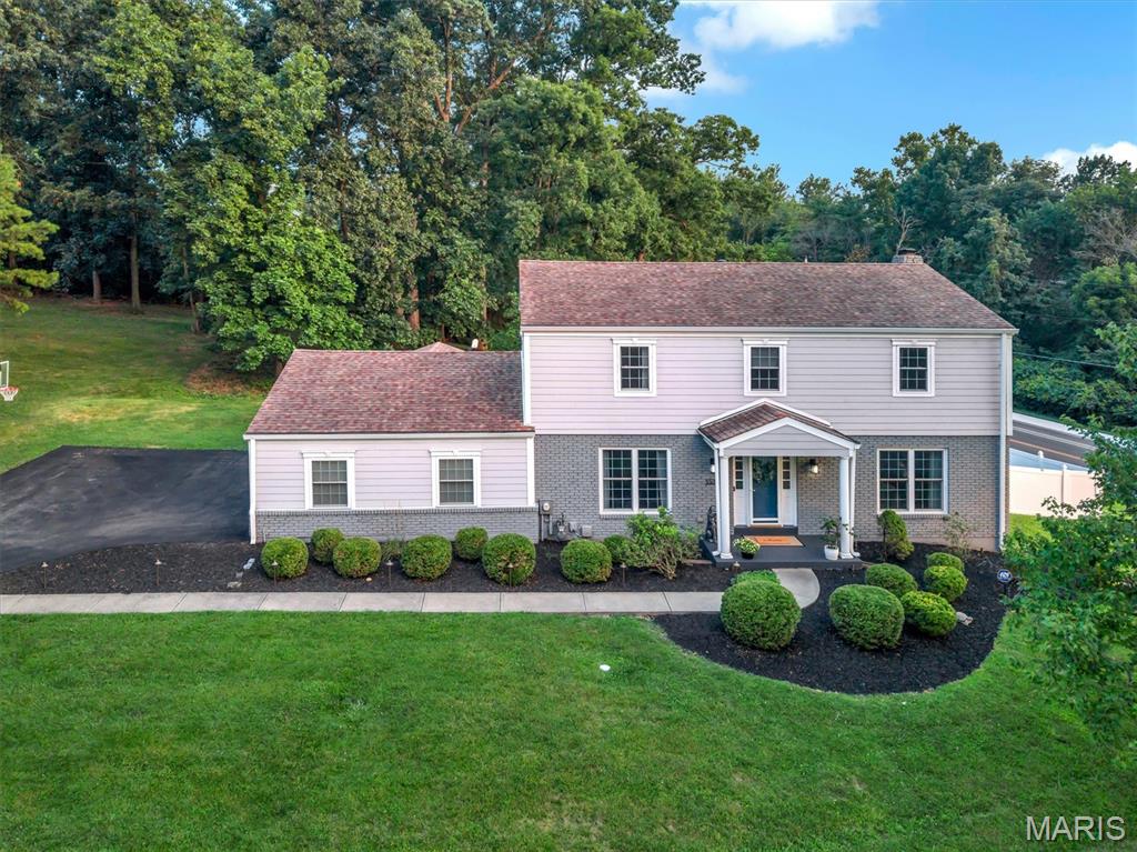 OPEN HOUSE Thursday 7/23 from 4-6:00pm! Welcome to this gorgeous 4-bedroom, 2.5-bath home situated on a beautiful 0.72 acre corner lot in the heart of Kirkwood! This exceptional property offers the perfect blend of charm, modern updates throughout and functional living spaces. Step inside to beautiful hardwood floors and an abundance of natural light that create a warm and inviting atmosphere. The spacious family room flows seamlessly into the living room, featuring custom built-ins, a cozy gas fireplace, and a charming bay window, an ideal spot to relax with a good book or enjoy your morning coffee. The beautifully updated kitchen is truly the heart of the home, showcasing a large center island, Cafe appliances, custom wood cabinetry, quartz countertops, abundant storage and a stylish coffee and cocktail bar. Just off the kitchen, the formal dining room provides the perfect setting for family dinners and entertaining guests. Convenience continues with a spacious main-floor laundry room and mudroom located just off the attached oversized two-car garage. Step outside to enjoy the large screened-in porch overlooking the expansive patio, deck, and private backyard offering plenty of space for outdoor entertaining, gardening or simply unwinding in your own peaceful retreat. Upstairs, you'll find three generously sized bedrooms, an updated full hall bathroom, and a spacious primary suite featuring a walk-in closet and a beautifully updated private bath. The partially finished walk-out lower level provides flexible living space ideal for a recreation room, home office, fitness area or playroom with additional unfinished space for storage. Perfectly positioned on a corner lot at the end of a cul-de-sac, this home is within walking distance of Kirkwood High School and just minutes from highways, shopping, restaurants, grocery stores, Kirkwood Park and the vibrant shops and dining of Downtown Kirkwood. This is a home you'll fall in love with. Don't miss your opportunity to make it yours!