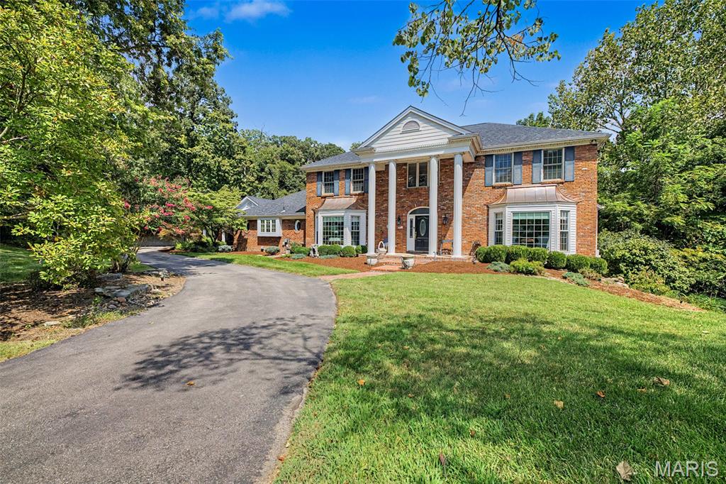 Stunning 1 1/2 story brick home with distinctive copper-topped bays, beautifully nestled on a semi-secluded 1-acre lot. From the moment you arrive, this exceptional property blends timeless elegance with comfortable, inviting spaces designed for everyday living and entertaining.
The main level features a formal living room and dining room accented by crown molding with both showcasing bay windows. The spacious custom kitchen is a chef’s dream, offering a 6-burner range, Beautiful granite counter tops, abundant cabinetry, walk-in pantry, and an impressive oversized center island with plenty of counter space. There is dedicated space for 2 refrigerators or a full sized upright freezer and refrigerator. Just steps away, the breakfast room showcases a beautiful bay overlooking the backyard and pool. A charming sunroom provides the perfect retreat to curl up with a good book or enjoy your morning coffee while taking in the peaceful surroundings.
The warm and inviting family room has the cozy character of a rustic cabin, creating a wonderful space for relaxing and gathering in front of the wood burning fireplace. There is also a main floor laundry room. The spacious primary suite offers a wood-burning fireplace and a luxurious primary bath complete with a deep soaking tub, separate shower, and double-bowl vanity.
Three additional bedrooms are located on the upper level, while a convenient fifth bedroom is situated on the main level. The expansive lower level provides even more living and entertaining space, featuring a recreation room, family room, office, additional sleeping area, changing room, full bath, and storage room.
Step outside and discover an entertainer’s paradise! Multiple patio areas, a deck, screened porch, and gazebo provide an abundance of options for outdoor gatherings and quiet relaxation. The centerpiece of the backyard is the gorgeous, oversized pool, creating the perfect setting for summer fun and memorable gatherings. There is expansive brick tiered landscaping and a running water fall. 
A 3-car side-entry garage includes one bay currently converted into a workshop, offering a fantastic space for hobbies or projects. The workshop could easily be converted back to garage space if desired.
With its spacious floor plan, exceptional outdoor amenities, beautiful 1-acre setting, and thoughtful blend of elegance and comfort, this extraordinary home offers a lifestyle that is truly one of a kind.