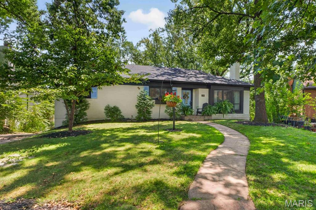 Second chance! Back on market at no fault of seller, with University City occupancy already passed! Welcome to this thoughtfully updated University City gem, where timeless charm meets beautifully curated design. From the moment you step inside, you'll notice the attention to detail, from the statement wallpaper in the entryway to the stylish lighting and finishes throughout. The inviting living room features a cozy wood-burning fireplace and beautiful custom built-ins framing the front window, creating a warm and welcoming focal point. It flows effortlessly into the dining room, creating the perfect space for gathering. An adjoining sitting room offers endless flexibility as a breakfast nook, home office, or playroom. The kitchen is both functional and beautiful, featuring custom cabinetry, granite countertops, a farmhouse sink, and stainless steel appliances. Three spacious bedrooms, a beautifully updated full bath with stylish tilework, and a convenient half bath complete the main level. Downstairs, the finished walk-out lower level adds incredible living space with brand-new flooring, a custom bar, a spacious recreation room, a dedicated laundry room, and an additional half bath, making it ideal for entertaining or everyday living. Just beyond, the screened-in sunroom offers the perfect place to unwind before stepping out to the patio and fully fenced backyard. With tasteful updates around every corner, this home offers the perfect blend of character and modern style. Complete with a tuck-under garage and located just minutes from the Delmar Loop, Forest Park, and all that University City has to offer. This is one you won't want to miss, it’s ready to go!