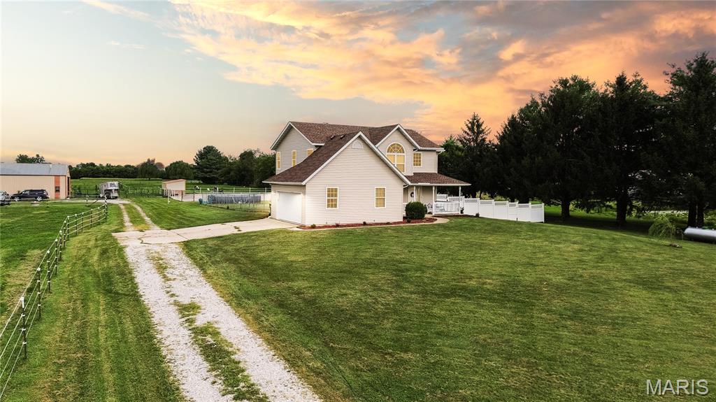 Discover the perfect blend of rural charm and modern updates in this beautifully maintained property on a private road in Edwardsville. Sitting on a well-kept parcel with multiple pastures, a spacious barn, and recent upgrades inside and out, this home is ready for its next chapter.
Step inside this 5 bedroom/4 bath home to find refinished hardwood floors (2025) and an updated kitchen with rich cherry cabinets and ceramic tile flooring. The home offers a functional layout with two HVAC systems for optimal comfort, one for the upstairs and one for the main floor and basement. Many mechanics have been updated, including A/C units, furnaces, water heater, and an ultraviolet water treatment system. The basement is fully finished (2009), offering extra living and entertaining space. The exterior offers recent improvements including new roof, siding, gutters, and patio door to the deck (2024), a fully fenced backyard with a 6’ chain link fence(2023), and fresh updates to the septic, sump pump, and water systems. For equestrian enthusiasts, the 36’ x 60’ barn features 7 stalls plus a birthing stall, tack room, and half bath, along with new horse watering spigot (2023). You’ll also enjoy 2 dry lots, a new 4-horse run-in shelter (2024), 3 electric-fenced pastures, and a fenced riding area. Whether you’re looking for a peaceful retreat or a fully equipped horse property, this move-in ready home offers space, privacy, and convenience, just minutes from Edwardsville amenities.