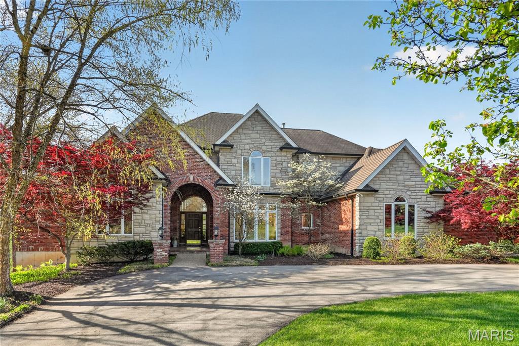 Spanning over 7,000 square feet, this exceptional brick residence offers a lifestyle defined by comfort and grandeur. The dramatic double foyer, soaring ceilings, oversized windows and extensive molding throughout create a striking first impression of architectural sophistication. The main level is designed for both intimate daily life and grand-scale entertaining. A seamless flow connects the formal dining room, the light-filled living area and the cozy hearth room, all centered around a well-appointed chef’s kitchen complete with a Sub Zero refrigerator, Wolf ovens, custom cabinetry and stone countertops. The expansive first-floor primary suite boasts both ease of living and privacy including a bay window, a spacious bath and a walk-in closet. A sophisticated office allows one to enjoy working from the comforts of home, a conveniently located main laundry and half bath complete the main level. An abundance of space for family & guests upstairs, with three additional spacious bedrooms, two full baths and ample closet storage. A fully finished walk-out lower level is a world unto its own, serving as the premier destination for recreation and relaxation featuring a dedicated theater area, wine room, workout and updated steam room and a full bar. All designed for effortless entertainment and social gatherings. Three zones recently replaced service the entire home, a newer driveway was just installed, an irrigation system and an oversized three car garage complete with new electric panels that will service level 2 charger for cars. Set in a private Ladue neighborhood and centrally located within close proximity to public/private schools, shops and restaurants, you won't want to miss out on this wonderful home.