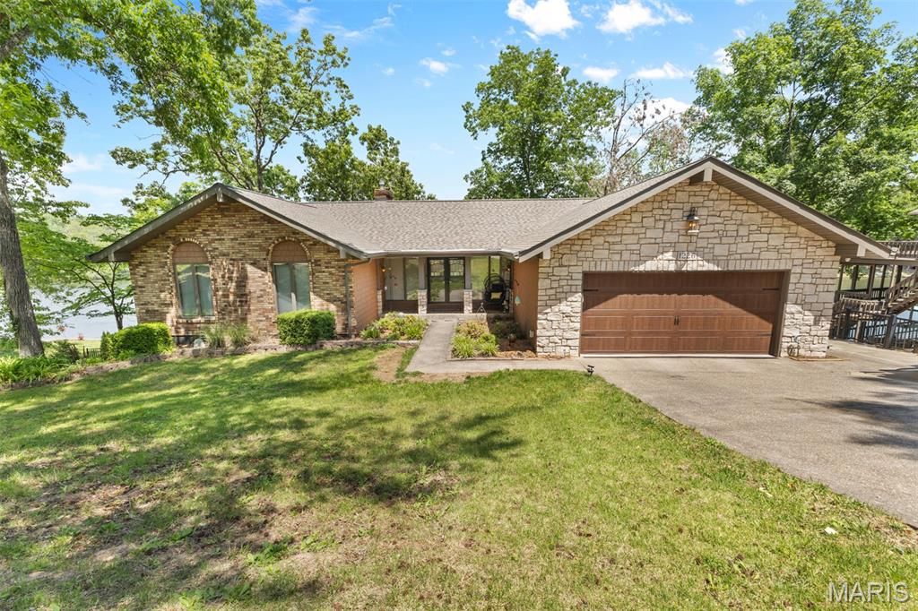 Stunning lakefront 4 bedroom 3 bath home with breathtaking views throughout! This spacious home features custom cabinetry, all natural stone countertops throughout home, Anderson windows and sliders, a beautiful brick fireplace, and expansive windows that bring the lake views inside. Enjoy outdoor living with both covered deck with stamped stone concrete and open Trek composite deck overlooking the water. The large finished basement offers a full second kitchen, plenty of storage, additional bedroom and bath, and bar area perfect for entertaining and easy access to the lake. Complete with a large dock, this property is ideal for relaxing, hosting guests, and enjoying lake life at its best.