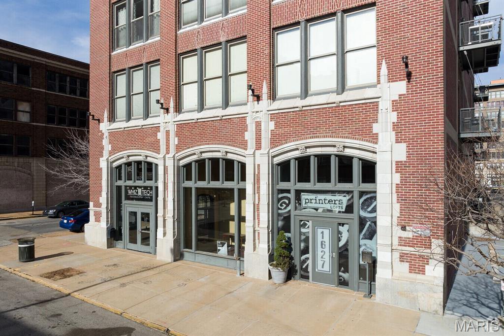**Home Qualifies for HomeSTL Homebuyer Assistance Program**

Experience downtown loft living in this stylish corner-unit condo located in the sought-after Printers Loft building. This 2-bedroom, 2-bath residence offers 1,244 square feet of thoughtfully designed living space featuring exposed brick, soaring 11-foot ceilings, abundant natural light, and an open loft-style layout. The kitchen is equipped with stainless steel appliances, a gas stove, and flows seamlessly into the main living area and private balcony.

Additional highlights include in-unit laundry with washer/dryer combo included in the sale, a dedicated storage room on the same level, and secure garage parking with one space featuring a lift system allowing for a potential second vehicle.

Residents of the Printers Lofts enjoy premium amenities including a fitness center, rooftop deck, community room, secure garage parking, and guest parking. Ideally situated in the heart of downtown St. Louis, the property is steps from 21C Museum Hotel and minutes from Energizer Park to enjoy CITY SC matches, Union Station and the iconic Gateway Arch.

A rare opportunity to own a true downtown loft combining character, convenience, and walkable city living.
