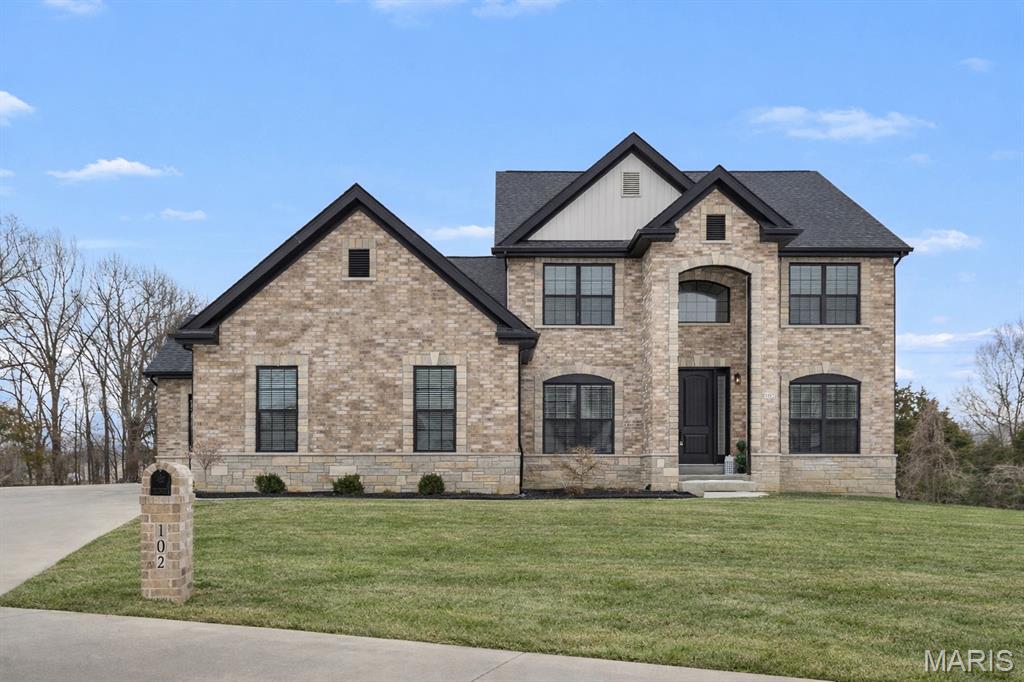 Completed in May 2023, this custom-designed 1.5-story modern farmhouse blends timeless architecture with refined, high-end finishes throughout. The striking brick and stone exterior, highlighted by an arched front porch, delivers exceptional curb appeal and a memorable first impression.

A grand two-story foyer opens to high ceilings and a light-filled layout featuring a private study, formal dining room, and an impressive great room with a 12-foot fireplace and large window wall overlooking the private backyard and pool. 

The designer kitchen featuring 42” custom cabinetry, quartz countertops, black stainless steel Kitchen Aid appliances, a large center island, and an adjoining breakfast room with direct access to the covered deck—ideal for entertaining.

Sophisticated interior details include hardwood flooring, custom 9-foot doors, designer lighting, and a built-in security system, all complementing the home’s open-concept floor plan.

The main-level primary suite serves as a private retreat, complete with a coffered ceiling, customized walk-in closet, and spa-inspired bath with a luxury shower.

Upstairs features three additional bedrooms and a full bath. The finished lower level expands the living space with a recreation area, family room with floor-to-ceiling fireplace, an additional bedroom, and a full bath with an elegant freestanding soaking tub.

Outdoor living is equally impressive with a patio, in-ground pool, and private wooded cul-de-sac lot providing peaceful surroundings. Additional highlights include a two-car garage plus a separate double-door entry garage space.

Conveniently located minutes from Busch Greenway, Chesterfield Valley amenities, and easy access to Highways 40, 94, and 364.

A thoughtfully designed, move-in-ready home that combines luxury, comfort, and location.