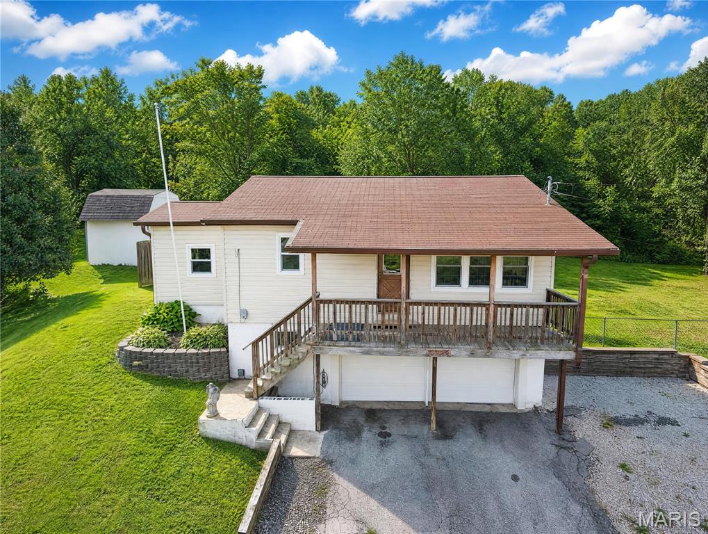 NEW PRICE & MOTIVATED SELLERS
This could be the one you're looking for! NO HOA!!  2+Bed 1Bath ranch home with 2-car tuck under garage and a separate 30x40 ft. garage with electric & water sitting on 2 lots in a great location in FOX C-6 School Distict. Tax Record only shows Lot 2 Parcel # 02-6.0-14.0-3-002-018. Lot 3 Parcel # 02-6.0-14.0-3-002-019 is included in this sale. Home offers a BRAND NEW Septic System installed in Nov 2025, newer windows, siding, gutters, and garage door on home. There is a spare room with an egress window and cedar closet that could be used as a 3rd bedroom, or office. There is also an enclosed back porch that leads to the fenced back yard and backs to trees/woods. Refrigerator in kitchen along with an electric dryer, sink, 2nd fridge & water softener in unfinished basement is staying with home, all in working order "AS IS" and nice size extra storage room with shelves. Sellers are also  leaving a Sound System & all window treatments. All this sitting on a private drive with two different ways to enter & exit is a plus! Home is being sold "AS IS"~SELLER WILL NOT DO ANY REPAIRS! Buyers are welcome to inspections at their own expense for informational purposes only. So many POSSIBILITIES/OPPORTUNITIES and lots to like about this unique property. Don't miss out, shedule your appointment to view now. Sellers will consider all offers!