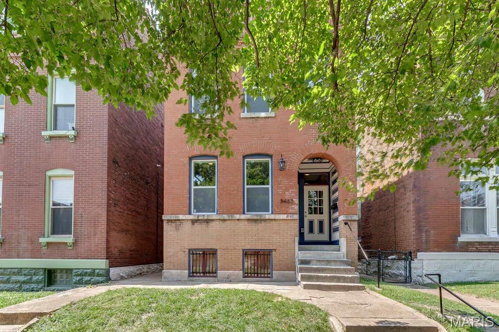 Welcome to 3437 Nebraska, a meticulously renovated, historic conversion located in the roaring Gravois Park neighborhood within a stones throw of Cherokee Street! Upon entry you are greeted by new hardwoods inviting you to an open, bright floor plan. Exposed brick, original staircase & recessed lighting gauges the eye. Living room & dining room are graced with space for entertaining. Kitchen is GORGEOUS: stainless steel appliances, quartz counters, tile back splash & center island perfect for gatherings. Dining area, half bath & 2nd entertaining area with access to rear wood deck complete the 1st level. Head upstairs to find a breathtaking primary suite with exposed brick, walk-in closet, primary bath featuring double vanities & tiled shower, & a private balcony. 2 additional bedrooms, full bath, & laundry room complete the 2nd level. Outside you'll find a fenced yard, wood deck & 2 car city garage! You can't beat all the updates including a new roof, original hardwood floors, new windows, new plumbing, new water service, new zoned HVAC and new electrical. Ceiling Fans & Recess lighting to suit. Revitalized & rehabbed with extreme care. Enjoy luxurious city living at it's finest.