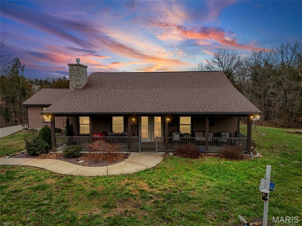 Spectacular Laiben built custom home on 2+ acres in Festus surrounded by farm land.  3 bedroom (2+office)/ 2 full baths. Tongue and groove ceilings and gorgeous full masonry gas fireplace exudes a lodge-like atmosphere. No expense was spared in the attention given to every detail of the home. High end windows, appliances and material throughout! Hardwood floors adorn predominantly throughout. Gorgeous concrete poured front porch to sit and watch the seasons unfold. But you won't be sitting on the front porch in the summertime!! You'll be sippin' that lemonade on your favorite raft in the in the Berry Govero in ground pool! I know,, know there's never enough storage? Well this property also includes a 48x40 outbuilding with a 16x8 loft and a 20x40 overhang that serves as stalls.