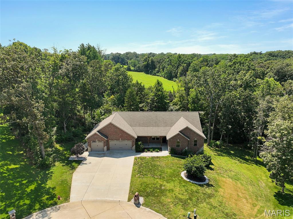 Looking for a place to enjoy a slice of the outdoors without giving up quick access to Washington and Union? Built in 2020, this beautiful 3-bedroom, 3.5 bath atrium ranch offers 1824 sq ft of main floor living space and an oversized, heated/cooled 3 car garage. This home sits on nearly a full acre in the Country Club Estates subdivision, just about a half mile from the Franklin County Country Club. 

The main level features a spacious open-concept living, dining, and kitchen area fitted with engineered wood flooring, recessed lighting, and a large quartz countertop island equipped with whirlpool appliances. To top it off, you get contemporary soft closed drawers and well crafted 42" cabinetry. Large windows and vaulted ceilings brighten this space with ample natural light throughout. Step directly from the dining/kitchen area onto the expansive covered composite deck, creating an ideal space for outdoor dining, entertaining, or simply enjoying the peaceful, tree-lined setting. 

The large primary suite features coffered ceilings, plush carpeted flooring, a walk-in closet, and an en-suite bathroom with dual vanities and a walk-in shower. Two additional main-level bedrooms are conveniently located near the laundry room and another full bathroom, which sits between all of the bedrooms for easy access. As an added bonus all of the doorways are dressed with artfully designed solid core doors. 

The partially finished walkout basement provides plenty of flexibility and space, with concrete floors, a full bathroom, ample storage, and a cozy space currently used as an entertainment/movie room. There is significant potential to finish this space and make it your own. A walkout leads to the lower concrete patio and the private, wooded surroundings.