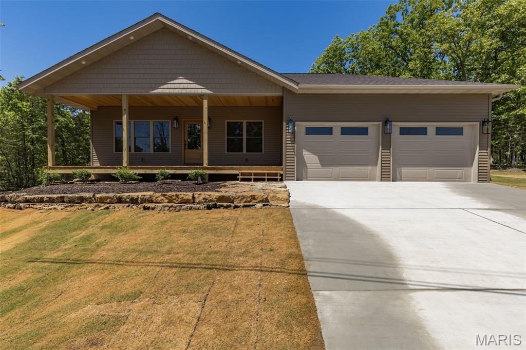 This beautifully crafted new construction home is packed with upgrades from top to bottom. The builder’s pride shows in every detail — from the 5/8 engineered wood flooring, crown molding throughout, and tall baseboards, to the upgraded carpet and padding in the bedrooms. Even the lighting fixtures were chosen for quality and style, giving the home a warm, finished feel.  The home offers 4 bedrooms (with the 4th featuring custom wainscoting and a built-in desk, perfect for an office), 2.5 baths, and   located next to Lac Lafitte.  The kitchen is loaded with high-end touches including custom cabinetry, quartz countertops, a pot filler, propane 6-burner cooktop, built-in oven/microwave, breakfast bar, and a built-in wine rack.  You’ll love the spacious laundry room with built-in cabinets and a folding counter, plus a handy mudroom drop zone with bench seating and hooks right off the garage. The living room features a cozy propane fireplace, and the 9-ft ceilings add an open, airy feel throughout the main level. The oversized 2-car garage offers 11-ft ceilings for extra storage.  Outside, the fresh Bermuda baseball sod and landscaping lead you to a welcoming covered front porch — the perfect spot for morning coffee or evening tea. The backyard includes a natural rock firepit area, ideal for gatherings, plus a covered side patio ready for your BBQs.  Quality, comfort, and thoughtful design come together beautifully in this home.