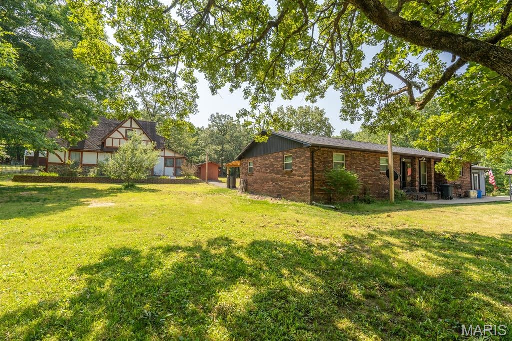 Looking for a private country property with room to live, work, raise animals, entertain, or create your own self-sufficient lifestyle? This one-of-a-kind 9-acre M/L property offers incredible versatility with two remodeled homes, a stocked spring-fed pond, barn, fenced areas, and numerous updates, no HOA or Restrictions!
The main brick home offers over 1,700 sq. ft. and features 2 bedrooms with the potential for a 3rd bedroom, 1.5 baths, an office, huge living room with wood stove, dining room, sunroom, oversized walk-in pantry, large laundry room, and covered back porch.
Major updates include:
Bosch HVAC installed in 2022
Kitchen appliances updated in 2022
Water heater installed in 2023
Roof replaced in 2017
Double-pane windows installed in 2017
Asphalt driveway sealed in 2023
Attic fan for additional ventilation and cooling
The property also includes a second two-story home, built after 2000 and recently remodeled. With approximately similar square footage to the main home, this flexible space offers multiple living or income-producing possibilities.
The lower level includes a kitchen, living area, bedroom, and full bath, while the upper level features a kitchenette, living room, two bedrooms, and a full bath. The layout could potentially be used as a second residence, guest quarters, multi-generational living space, or rental opportunity with separate living areas.
Outdoor features are equally impressive! Enjoy a stocked, spring-fed pond of approximately one acre, a barn with two large stalls, tack room, extensive storage, water, and electricity, plus a chicken coop, fenced area for chickens or goats, room for horses, and a corral.
The property also includes an artesian well with a hand pump, providing an additional water-access option during a power outage. There is also a designated area at the back porch for connecting a propane or gasoline-powered generator.
All kitchen appliances are included. Washers, dryers, and freezers are excluded.
With 9 acres M/L, two homes, livestock facilities, a stocked pond, and extensive infrastructure, this property offers opportunities that are hard to find in one package. Please note: The property will be surveyed prior to sale. An additional 9 acres M/L are available, and the total room count and square footage includes both homes.