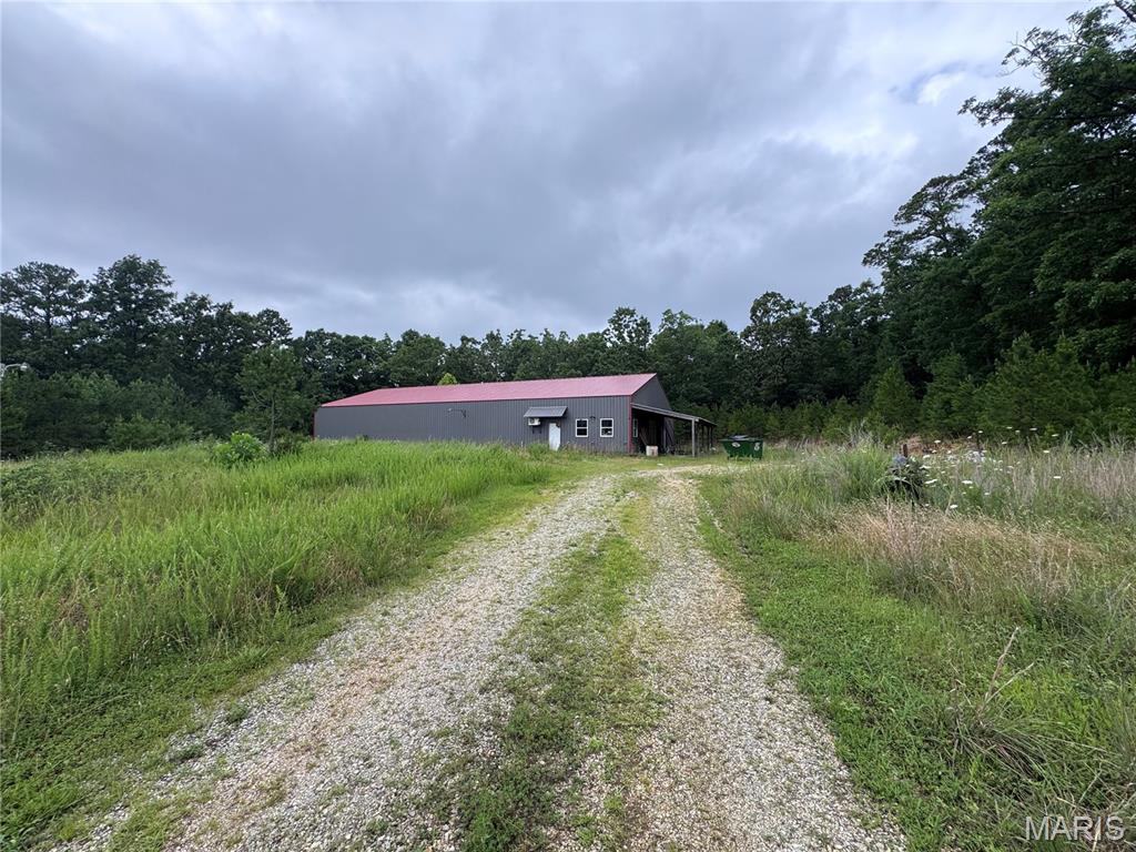 STOP!!! Yes, I said 4.49 Acres with existing 5,000 Sq. Ft. Metal Building with Endless Potential!
Looking for the perfect place to build your dream home, start a business, or create a combination home and shop? 
This 4.49-acre property in Texas County offers incredible flexibility for residential, recreational, or potential commercial use.
The spacious 5,000 Sq Ft metal building is already equipped with a bathroom, office space, and an area that could easily be finished into a kitchen. Whether you're looking for a workshop, storage, business headquarters, or a place to live while building your dream home, this property provides endless possibilities. With plenty of room to expand, you can design the ideal home/shop setup or take advantage of the property's many other potential uses. Don't miss this unique opportunity to own a versatile property with so much to offer. 
Schedule your showing today! New Pictures to come.