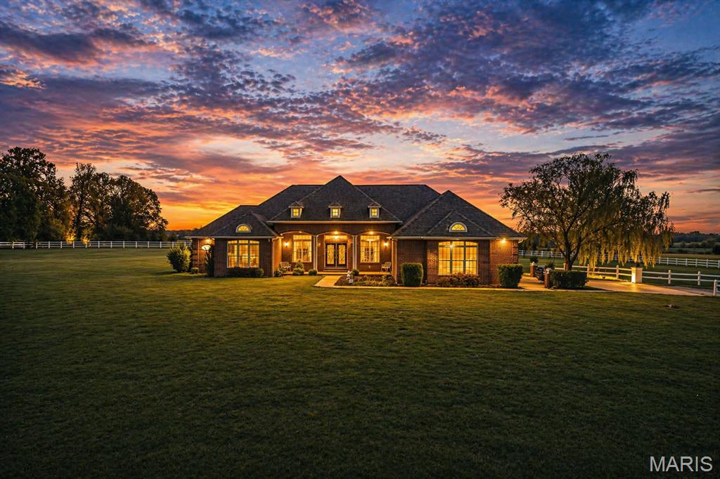 Set on 10 acres of lush, fenced countryside, this distinguished brick estate offers an exceptional blend of refined interior living and expansive outdoor opportunity. Thoughtfully designed with both elegance and functionality in mind, the home welcomes you with impressive 12-foot ceilings and beautifully appointed gathering spaces throughout. The formal dining room showcases marble flooring, creating a sophisticated setting ideal for hosting. At the heart of the home, the kitchen features a large center island, granite countertops, a Jenn-Aire stove, and a designated breakfast area with hardwood flooring, providing both everyday comfort and elevated entertaining space. Just beyond, the family room with an electric fireplace offers a warm and inviting retreat, while the formal double-sided sitting room adds timeless character and versatility. The spacious primary suite includes his and her closets and a luxurious ensuite bath complete with double vanity, jetted tub, separate shower, and an elegant crystal chandelier-a true private sanctuary. Additional highlights include an oversized laundry room with sink and extra storage, hardwired smoke detectors throughout the home, and enhances wall insulation for comfort and efficiency. Practical upgrades continue beneath the home with a 4-foot lighted crawlspace, and peace of mind comes with a brand new roof just recently installed within the last month. (June 2026) For an additional acreage, see MLS 26037917. A rare opportunity to own a refined country estate with acreage, privacy, and thoughtful upgrades throughout. Call us to schedule your showing today to see if this could be YOUR next home!
