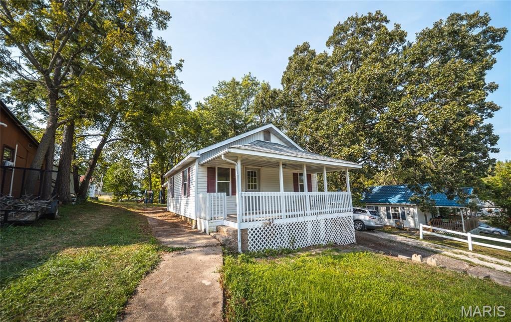 Welcome home to this beautifully remodeled 2-bedroom, 1-bath home nestled in the heart of Crocker, Missouri. Blending small-town charm with fresh, modern updates, this move-in-ready property is the perfect place to settle in and feel at home from day one. Step inside to discover a bright and inviting interior that has been thoughtfully updated throughout. Fresh paint, new flooring, updated fixtures, a remodeled kitchen, and many additional improvements give the home a clean, refreshed feel while maintaining its cozy character. The functional layout makes great use of the space, whether you're relaxing after a long day, entertaining friends, or enjoying a quiet weekend at home. Outside, mature trees provide welcome shade and create a peaceful setting to enjoy throughout the seasons. The charming covered front porch is just waiting for a porch swing, rocking chairs, and your morning cup of coffee—a perfect spot to slow down and enjoy small-town living. Conveniently located in Crocker, this home offers easy access to local schools, businesses, and everyday amenities while providing the comfortable atmosphere of an established community. Whether you're searching for your first home, looking to downsize, or adding to your investment portfolio, this completely remodeled property is ready for its next chapter. Schedule your private showing today and come see this charming Crocker home for yourself!