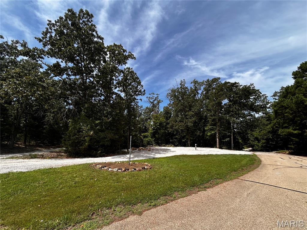 Seller will give $2,500.00 allowance towards buyer to add water to their property.  Buyer will need to do this after closing. 
DON’T PACK UP THE CAMPER JUST YET! 2198 Compass Circle at Lake Perry is your ticket to enjoying
the great outdoors ALL YEAR LONG! Think summer is the only season for Lake Perry? Think again! Fall
and winter may just be when this beautiful lake shines its brightest! Picture crisp fall mornings, colorful
trees reflecting across the water, cozy evenings around your large natural-rock fire pit, and peaceful
winter sunrises that make you stop and take it all in. This camping-with-permit lot is ready for your next
adventure and offers: Circle drive for easy access, Two 50-amp RV/Camper hookups, Two 110 outlets
for your convenience. Large natural-rock fire pit — perfect for s’mores, stories & stargazing, Camping
permit lot ready for seasonal enjoyment, Full access to Lake Perry’s 200-acre lake, Marina & 
recreational center, Sandy beaches, Playgrounds, Shower houses (at the Recreational center and West
Gate, Coin laundry area.) And then there’s that magical Lake Perry sunrise… As the first light illuminates
the water and surrounding nature, Lake Perry comes to life each morning, reminding you why this is
such a special place to escape, unwind and make memories. Fall camping? Absolutely! Winter lake
getaways? You bet! Spring adventures? Yes! Summer fun? Of course! Why wait until next summer to
enjoy Lake Perry? Come see for yourself why every season has something special waiting for you at
2198 Compass Circle!