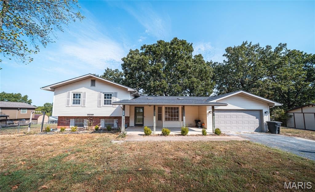 Welcome home to this beautifully updated 3-bedroom, 2-bath multi-level home, nestled in a quiet neighborhood just minutes from the heart of town and Fort Leonard Wood. With inviting indoor and outdoor spaces, thoughtful updates, and plenty of room to spread out, this home is ready for its next chapter. A charming covered front porch welcomes you inside to a refreshed interior designed for comfortable everyday living. The showstopper is the spacious updated kitchen, featuring a large center island that creates the perfect gathering place for morning coffee, weeknight dinners, or entertaining family and friends. Just off the kitchen, French doors open to a convenient mudroom that leads to a generous pantry and additional storage area, making it easy to keep everything organized. The primary suite offers a peaceful retreat overlooking the fenced backyard, where mature shade trees create a relaxing setting for outdoor dining, pets, play, or quiet evenings at home. Downstairs, the lower level adds valuable living space with a cozy family room centered around a wood-burning fireplace—perfect for movie nights or relaxing on cooler evenings. An additional full bathroom on this level provides extra convenience for family and guests. Enjoy the peaceful neighborhood setting while staying close to shopping, dining, everyday amenities, and Fort Leonard Wood. With its updated interior, flexible multi-level layout, and welcoming outdoor spaces, this home offers comfort and convenience in one great package. Schedule your private showing today and come see what makes this home special!