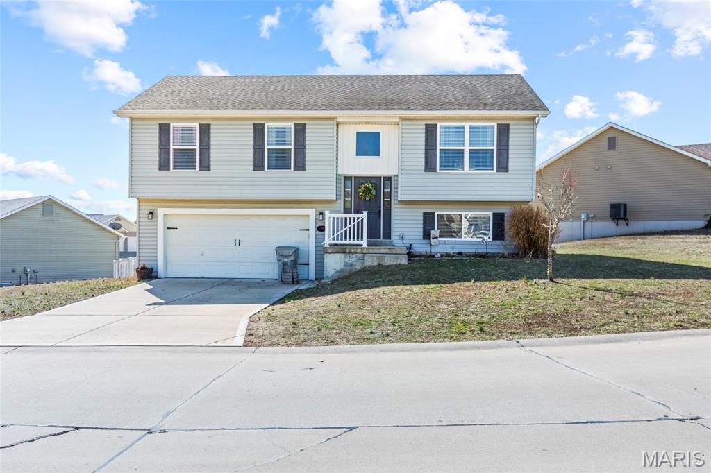 This move-in ready home is turn key and ready for its new owner! The modern kitchen features granite countertops, multiple built-ins including a charming plate rack, and brand-new LG appliances (stove, microwave, refrigerator, washer, and dryer), all added in 2024 and included with the home. The fully finished basement offers versatile living space with custom shelving—ideal for a family room, home office, or gym.  The laundry room is also finished, and is ready for your new craft area or additional storage -- you decide!  It features a private, fully-fenced backyard complete with a 14' x 16' deck—perfect for entertaining, relaxing, or outdoor dining.  It also comes with a riding lawnmower to help with the large yard! An oversized garage (longer than the newer build 19' standard -- bring your trucks!) provides ample storage and workspace. Inside, you’ll find stylish luxury vinyl plank flooring throughout, neutral paint, and an open, inviting layout. Additional highlights include a whole-house water purifier, water softener, and water heater replaced in 2022, ensuring comfort and efficiency. The primary bath also features built-in shelving for added convenience. With thoughtful upgrades throughout and nothing left to do but move in, this exceptional home is truly turnkey. Schedule your private showing today!  Showings start 3/2, open house 3/8 from 1-4 pm!