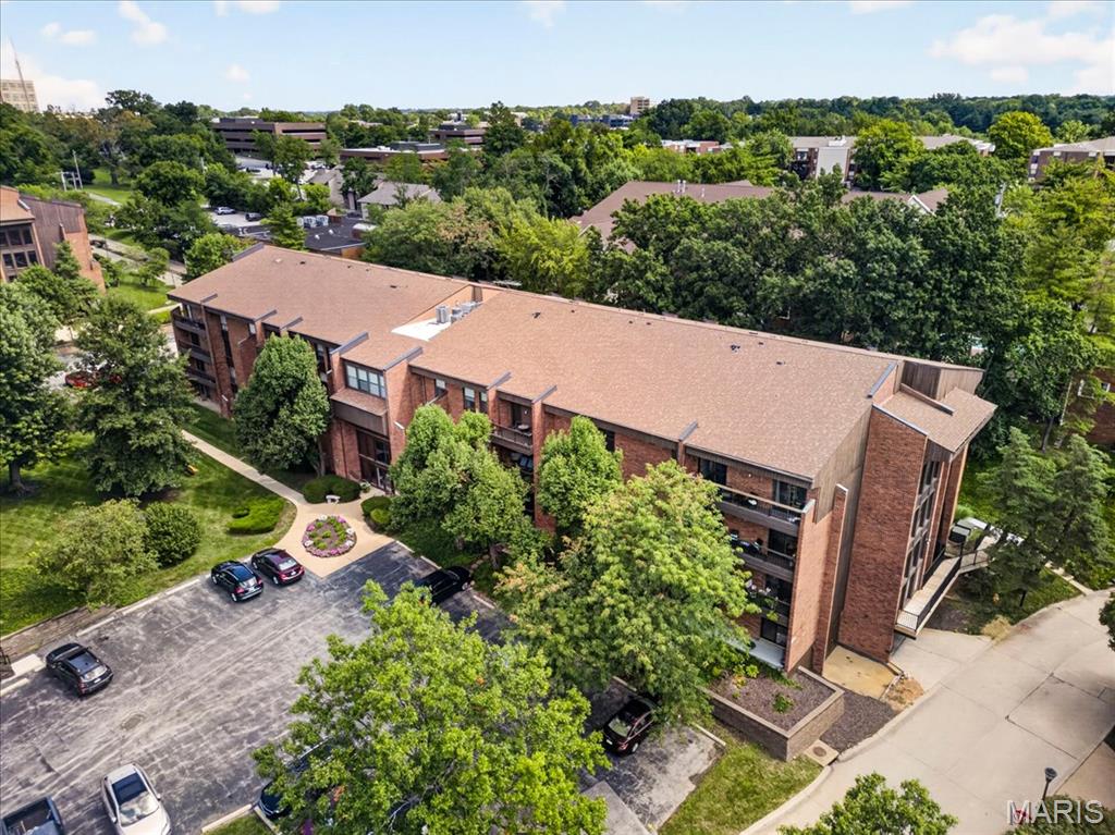 Top-floor living, the community’s largest floor plan and two garage spaces—this one stands apart! Located on the fourth floor of a secure, elevator-served building, this beautifully maintained 3-bedroom, 2-bath condo offers a spacious, comfortable layout with hardwood flooring throughout the main living areas. The generous living room flows into a large dining area, while the updated kitchen features abundant cabinetry, quartz countertops, stainless steel appliances, a tile backsplash and convenient breakfast bar. Step outside to the private covered balcony overlooking mature trees. The spacious primary suite includes a beautifully remodeled bath and an impressive walk-in closet with custom organization. Two additional bedrooms offer flexibility for guests, a home office or den. Additional highlights include in-unit laundry (washer/dryer included), two assigned garage spaces—an uncommon offering within the community—and abundant guest parking. Residents also enjoy a welcoming lobby, swimming pool, tennis courts and beautifully maintained grounds, all in a convenient Creve Coeur location. Spacious, updated and move-in ready!