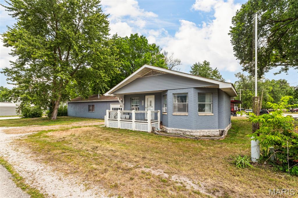 Coming Soon. Showings begin 7/23.
Professional photos 7/22.

Looking for a home with an enormous shop and garage? You found it! This 3-bedroom, 1 bathroom brick ranch sits on nearly a half-acre corner lot with a beautiful, parklike setting right in the heart of Old Monroe. From the covered front porch, you are greeted by a bright, open floor plan filled with natural light. The spacious great room features high ceilings, a cozy wood-burning fireplace, and a large bay window that seamlessly flows into the adjoining kitchen and dining area.

The kitchen has lots of updates with newer appliances, some new doors, new flooring, and fresh paint throughout.
Down the hallway, you will find 3 bedrooms, a full bathroom, and a convenient main-floor laundry room.
The attached shop is an absolute must-see! Measuring an impressive 62’x26’, it comes equipped with a furnace, built-in workbench, ample storage, a side-entry service door, and pull-through garage doors located in both the front and back. Use this massive space as a traditional 2-car garage with an expansive adjoining workshop, or open it up completely as one massive dream shop that can easily accommodate up to 6 cars. Schedule your showing today!