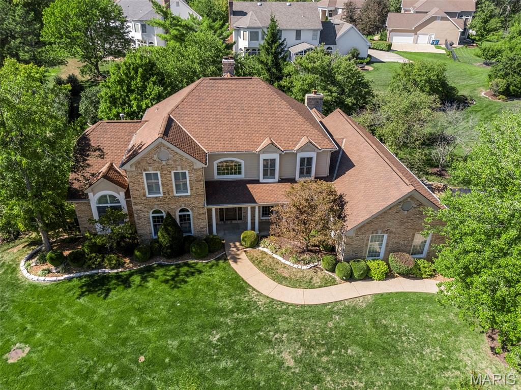 Stunning 1.5-story, 4 bed & 6 bath, a former display home in the highly sought-after Brooke Hill Esfates, thoughtfully designed and loaded with upgrades. A dramatic two-story entry with a sweeping staircase opens to the study and dining room, leading into the great room with hardwood floors, soaring ceilings, crown molding, a striking floor-to-ceiling fireplace, and walls of windows that flood the space with natural light.

The gourmet kitchen is a chef’s dream, featuring a center island, Thermador appliances, beverage center, and wine fridge, and opens to a bright, cozy hearth room with gas fireplace.

The main-floor primary suite offers a luxurious retreat with a spa-inspired bath including heated floors, heated towel rack, and a custom dual walk-in closet. Upstairs, you’ll find three spacious bedrooms, two full baths, and a loft with built-in shelving. The finished lower level provides even more living space with a family room and fireplace, half bath, bonus/workout room, and a hidden game room tucked behind a secret door!
Additional features include plantation shutters, updated baths, zoned HVAC, custom closets and pantries by NewSpace, a 3-car side-entry garage with EV charging, and an oversized patio perfect for entertaining. All in an unbeatable Chesterfield location close to shopping, dining, and top-rated schools. Don’t miss this one!