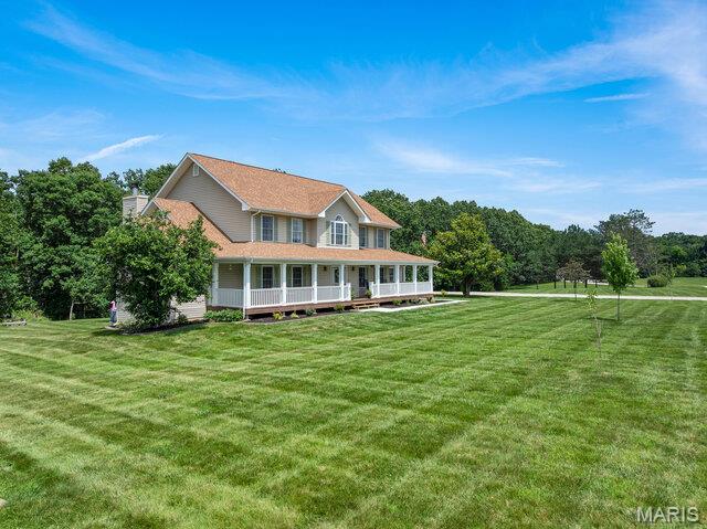 LAKE FRONT PROPERTY!  Beautifully remodeled two-story home offering over 3,400 square feet of finished living space on 5 picturesque acres with a shared lake. This spacious home features 5 bedrooms, 3.5 baths, and an incredible primary suite with a luxurious, fully remodeled bathroom.  This main floor primary suite is 16x15 features coffered ceilings, luxury bath with dual vanities, new soaker tub, separate shower w/custom tile surround & custom glass enclosure & large walk in closets with custom shelving. The entire home has been thoughtfully updated, including a remodeled split staircase, fresh paint throughout, beautifully updated bathrooms, a brand-new deck, new sidewalks, landscape curbing, and newly planted trees that enhance the property's curb appeal. Inside, you'll appreciate the natural light & abundance of closet space and storage throughout the home. The stunning kitchen is designed for both everyday living and entertaining with 42" Amish custom-built cabinetry, a newer  tile backsplash, stainless steel appliances, double wall ovens, a large center island, walk-in pantry, and new luxury vinyl plank flooring throughout the main level. The spacious main-floor laundry room offers convenient access to the new deck. The living room is filled with natural light from the triple bay window & features a cozy electric fireplace. Upstairs, you'll find four additional generously sized bedrooms all with large closets and a full bath, providing plenty of room for family or guests and a cozy sitting area. The walk-out lower level includes a full bathroom, French doors to your huge patio, 4 egress windows, completely framed in & some electric has been ran & is ready for your finishing touches, offering endless possibilities for additional living space, a recreation room, home gym, or guest suite. Sellers have recently professionally cleared out woods & underbrush for an easy, path to your Lake! Other features include 3 car garage is finished with insulated garage doors & dual geothermal units & newly paved road. Located on a quiet 5 acres with an above ground pool & shared lake tucked away in your back yard.  Just 12 minutes from I-70 in Warrenton, this exceptional property offers peaceful country living with an easy commute to both St. Louis and Columbia. This move-in-ready home truly has the space, updates, and setting you've been looking for!