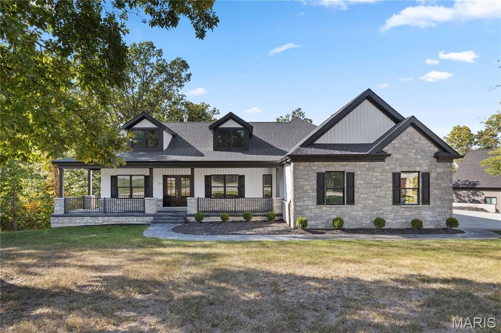 New construction ranch home on 1.7 acres in the Woods of Sandy Creek. Scenic wooded views. Premium stone elevation.  Open floor plan. Vaulted great room with floor-to-ceiling stone wood-burning fireplace. Gourmet kitchen with waterfall center island, white Samsung Bespoke appliances, custom tongue and groove cabinetry, walk-in pantry, and breakfast area. Luxury master suite with coffered ceiling, barn door, private deck access, glass shower, dual vanities, soaking tub, and walk-in closet. Main level front office. Large maintenance-free covered back deck with black aluminum railings. Finished walk-out lower level with bedroom, bathroom, rec room, bonus room, storage, safe room, and patio. Luxury wide-plank wood flooring throughout. Quartz countertops and full slab quartz shower walls throughout. Custom tile work. Seamless dimmable can lighting throughout. Oversize three-car garage with full drywall. Stamped concrete bordered driveway. Covered wraparound front porch. Double front entry door. Architectural shingle roof. Six-inch seamless gutters. Automatic dusk-to-dawn outdoor lighting. Sought after neighborhood with paved streets. Quick access to 79.
