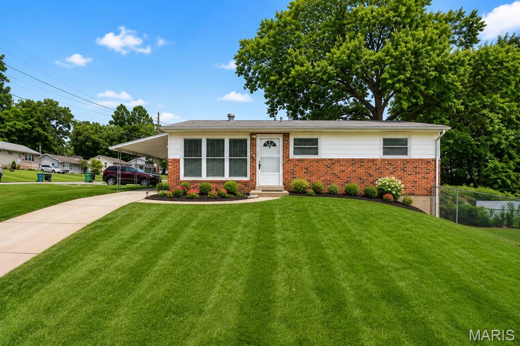 MOVE-IN READY, SUPER CLEAN & BEAUTIFULLY MAINTAINED! Pride of ownership shines throughout this charming home. You'll love the beautiful original hardwood floors in the living room, hallway, and all bedrooms. The spacious updated eat-in kitchen offers abundant cabinetry, ample counter space, and plenty of room for family gatherings. The updated bathroom adds modern appeal, while newer thermal windows provide energy efficiency and natural light throughout. Step outside to enjoy the covered patio/carport with brand new concrete floor, perfect for outdoor relaxation, along with multiple off-street tandem parking spaces. Situated on a level corner lot with an oversized side yard, there's plenty of room for gardening, entertaining, or play. The walk-out lower level offers endless possibilities for future finishing, additional living space, or generous storage. Conveniently located and meticulously cared for. Passed St. Louis County occupancy inspection. Fridge, washer and dryer stay for your convenient. This home is truly move-in ready and waiting for its next owner!