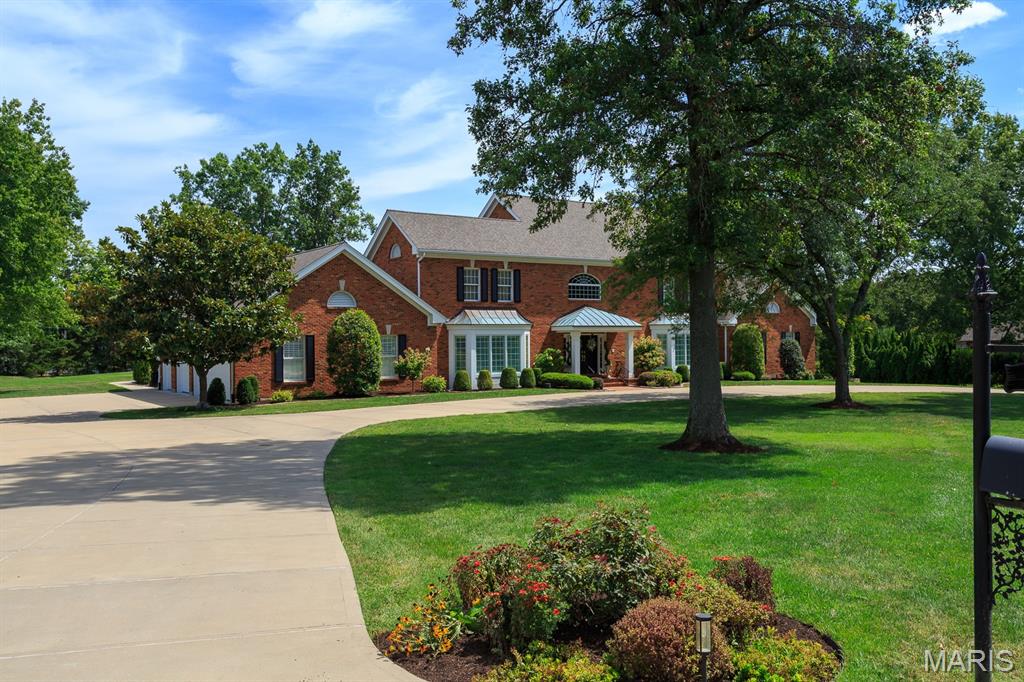 Welcome to an Exquisite property in Country Life Acres, an exclusive gated community where luxury meets timeless elegance. Discover sophistication in this 1.5-story home,  w 4 bed & 9 baths, offering 7,000 sq ft of refined living on a 2-acre level lot, w 2 MASTER SUITES on main level for ultimate privacy. A stately concrete circle drive sets the stage for the grandeur within. The dramatic 2-story foyer w arched passages flows into elegant living & dining spaces, perfect for gracious entertaining. The great room impresses w soaring ceilings, Palladian windows, a grand gas log fireplace, intricate custom woodwork, & hardwood floors. At the heart of the home is an updated gourmet kitchen—two expansive islands, granite countertops, & custom cabinetry—leading to a sunlit breakfast room overlooking the stunning saltwater pool. This outdoor oasis features a newer Kool Deck, elegant brick coping, & wrought iron fencing w stately brick pillars, ideal for serene relaxation or lavish gatherings. The main floor offers 2 master suites, an oversized office, & a versatile TV room easily could convert to an in-law suite. Upstairs, 2 spacious bedrooms w ensuite baths. The lower level includes 2 finished baths, formerly live-in staff quarters. Car enthusiasts will appreciate the heated/cooled 3-car side-entry garage w extra storage. A newer roof & exceptional amenities complete this distinguished well maintained property. Experience one of Saint Louis' most exclusive communities.