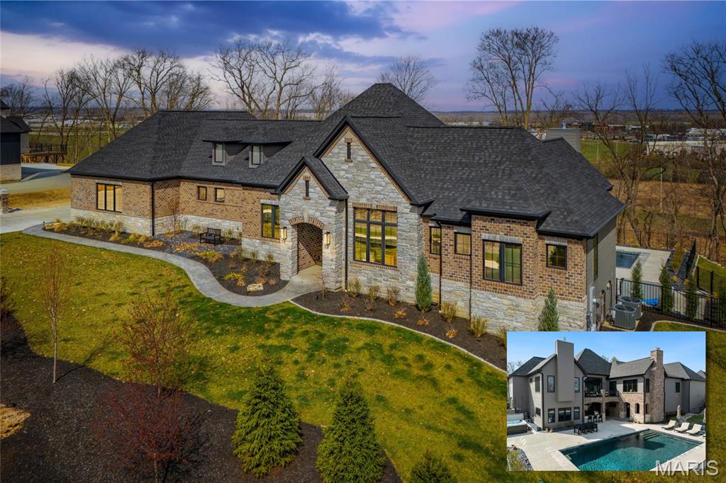 An extraordinary opportunity to own a truly bespoke estate at 17435 Wild Horse Creek Road, where refined design meets modern luxury. This exceptional residence will be featured this Fall in St. Louis Magazine, a testament to its architectural presence and elevated finishes throughout.

Thoughtfully curated interiors showcase Restoration Hardware lighting throughout the home, creating a warm, sophisticated ambiance. The chef’s kitchen is a true showpiece, featuring luxury appliances, a striking waterfall island, and custom cabinetry designed for both beauty and function. Entertain with ease in the formal dining room, or retreat to the private office, ideal for focused work or quiet study.

The primary suite is a serene sanctuary, highlighted by a fireplace, private access to the deck, dual walk-in closets, and a spa-inspired bath with dual vanities, a separate soaking tub, and a luxury walk-in shower. A private laundry room within the suite adds exceptional convenience. Two additional main-floor bedrooms each offer well-appointed en suite bathrooms, providing comfort and privacy for family or guests. A spacious main-floor laundry includes a pet shower, thoughtfully designed for modern living.

The walk-out lower level expands the home’s versatility with two additional bedrooms, one with an en suite bath, a third laundry room, and a generous family room with fireplace. A full second kitchen opens directly to the outdoor living space, making entertaining effortless. Step outside to the covered patio with fireplace, which walks out to the pool, creating a resort-like setting ideal for gatherings or quiet evenings at home.

Completing this remarkable property is a four-car garage, plus a fifth garage space equipped with a car lift, offering exceptional storage and flexibility for automotive enthusiasts. Every detail of this residence reflects intentional luxury, timeless design, and elevated everyday living.