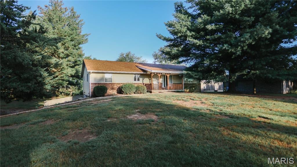 Welcome to this inviting home featuring three comfortable bedrooms and two bathrooms. The living room centers around a beautiful, cozy stone fireplace, perfect for warm, relaxing evenings. Outside, enjoy a spacious and picturesque 1.67 acres ideal for living and entertaining or just relaxing! The unique basement offers flexible space that can serve as a workshop, a quiet treat or with the custom bar an additional area for gathering! Custom woodwork throughout! Other amenities include an oversized 2 car garage. You also get shared lake access! You have to see this for yourself! Home is on 2 parcels. All measurements should be independently verified by the buyer. The Kallie's cabinet sign does not stay as long as furniture. Closing date to occur on or after November 30th, 2026. SOLD AS-IS!