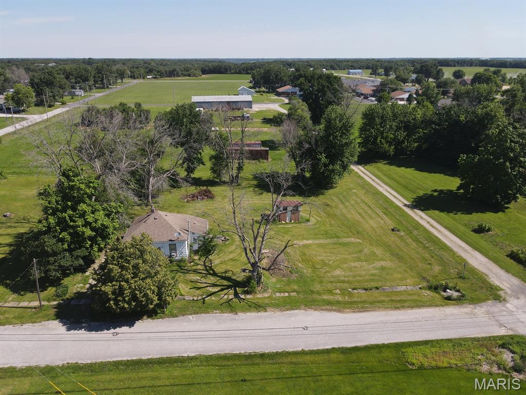 It is hard to find city lots!  They are in high demand and rarely hit the market, so don't let this oversized 150x137 level lot pass you by.  Located on the north side of Kahoka along Grant St, the lot is tree lined on the west & north sides, with street frontage to the south & east.  This provides multiple building-site options, or bring you ideas and renovate the 881 sq ft bungalow that is ready for your finishing touches.  Offering a nice layout, 2-beds, 1-bath, a sunny kitchen and spacious living & dining rooms - there is definitely potential here!  There is a partial basement, forced air furnace and window-unit air conditioning.  Homes in this price range do not come along often, and after renovations your home equity will be drastically different.

Utility providers here include city electric, water, sewer, trash, Liberty Gas, and Rise Fiber is available.