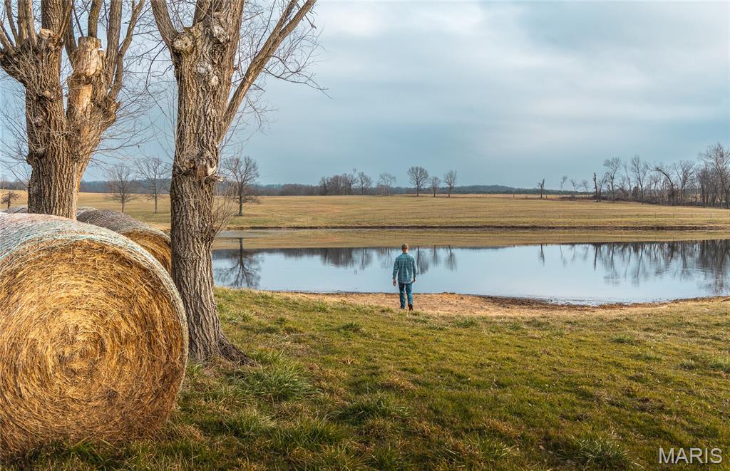 Exceptionally clean 91.5± acre turnkey cattle farm offering productive ground, income potential, and a stocked lake—ready to use from day one. Recently surveyed and fully fenced with new 5-strand barbed wire, including cross fencing. Nearly every acre is usable for grazing or hay production, with over 300 large round bales produced last season. A spring-fed creek provides reliable year-round water for livestock.

The property features a well-maintained 3± acre stocked lake with bass and crappie, adding both functional water access and outstanding recreational value. Improvements include a dry antique barn with capacity for approximately 180 round bales plus equipment storage, a calving shed, and an additional storage shed.

A charming 2-bedroom, 1-bath farmhouse is currently rented, offering immediate income or the option for owner occupancy. The land is nearly flat with gentle elevation changes that create incredible west-facing views overlooking pasture and lake. Electric runs across the property at the hilltop, making it an ideal future homesite.

Nearly a half mile of paved road frontage provides easy access. Conveniently located just 12 minutes from Potosi and just over an hour from St. Louis. Excellent long-term potential for a multi-home estate, family retreat, or shared ownership property. Deer and turkey are abundant, with trophy bucks harvested.

Call today to schedule a private tour.