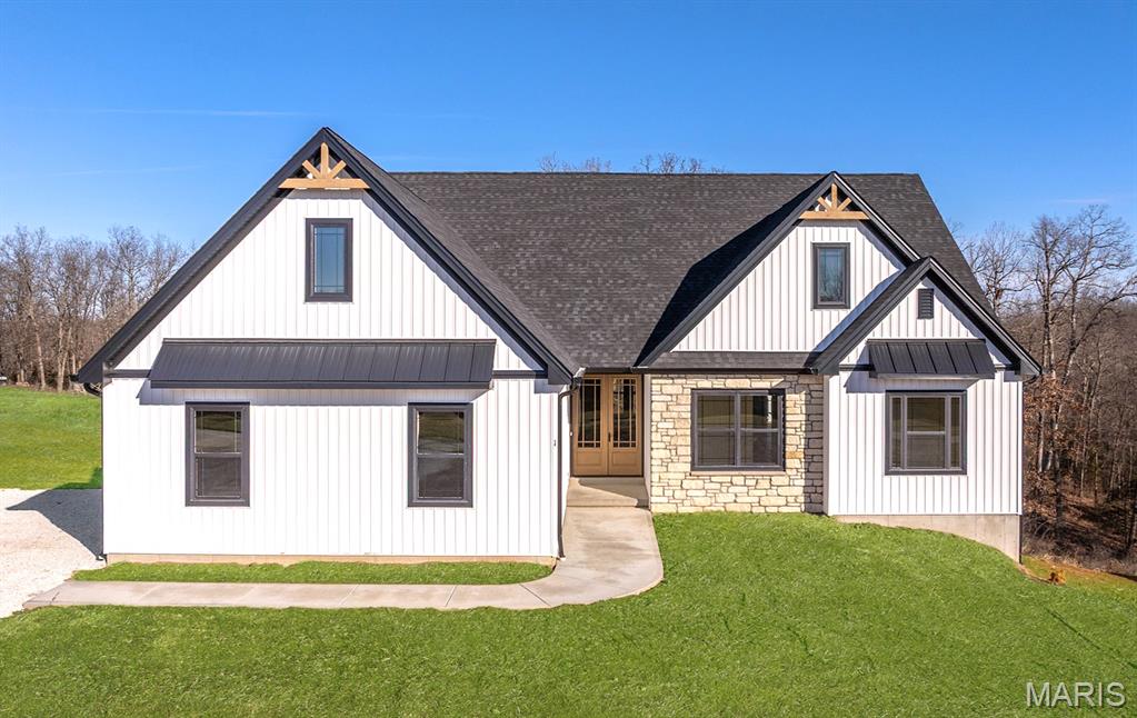 MOTIVATED SELLER HE SAYS MAKE AN OFFER! The search is over! A home of truly remarkable craftsmanship that checks every box sitting on 5+/- acres in Silex, Mo! This brand new home boasts 1950 sq ft of living space with 3 sizeable bedrooms and 2 full bathrooms. Enter through the 8ft nearly full glass door into your open main living space with 11 ft ceilings. Living room features a stone wood burning fireplace adjoined by recessed built in shelving, coffered ceiling with box beam inlay and a wall lined with over-sized windows accompanied by transom windows that let in so much natural light you'll never need to touch the light switch. The kitchen is magazine-cover worthy with full quartz counter tops, huge center island with farmhouse sink and enough cabinet space that the only thing you'll need to keep in the 8x5 pantry is food! Master bedroom is large enough to be considered its own apartment and has a 9x7 walk-in closet and ensuite bathroom with cave shower, double bowl vanity and linen closet. Walk-out basement is ready to be finished off however you could imagine and has extra water lines ran to easily put a wet bar and make it the perfect entertainment space. Have a project that needs finished up? Pull it in to the oversize 3 car garage measuring 30 ft wide and 25 ft deep with 8 ft tall doors and TWO 220 volt outlets and if you manage to fill that up, don't worry because there is a great spot on the property to build a detached garage/shop! Other features include 93% efficiency propane furnace with built in whole home humidifier and 14x14 back deck with disconnect for mini split if you ever wanted to enclose it and make it a 3 season room.