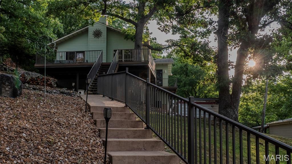 An exceptional opportunity for lakefront living awaits at the 31 Mile Marker on the Linn Creek Arm in Camden County, Missouri. This meticulously maintained property offers a seamless transition to lake life, boasting a fully furnished residence and a comprehensive dock setup designed for immediate enjoyment. With a recent home inspection completed and the benefit of NO HOA fees, this offering provides both quality and flexibility.

The 1401 Sq. Ft. home, built in 1991, features an open concept floor plan with 2 bedrooms and 2 bathrooms, providing comfortable accommodations. Practical amenities include a fireplace and trash compactor, while all appliances, including the washer and dryer, remain with the home. Designed for effortless ownership, the property benefits from zero-maintenance landscaping, metal siding, and composite decking on both a wide wrap-around walkway and the rear deck. An aerated septic system, full electric service, and an oversized crawl space further enhance the home's functionality.

The true highlight of this offering is the exceptional deep-water dock infrastructure. A concrete walkway leads directly to a covered 23' x 48' dock featuring durable concrete decking. This robust setup includes a 36' x 15' slip equipped with a 21,000 lb Hydro Hoist with poly tanks, two dock fans, and two dock cabinets. Further enhancing confidence, the dock underwent a thorough inspection by Ameren in 2024. An oversized parking area ensures ample space for vehicles and lake toys.

Accessible via a paved road, this property is served by essential utilities including electric, water, and septic. Every detail has been considered to provide a turnkey lakefront experience in a highly desirable location.