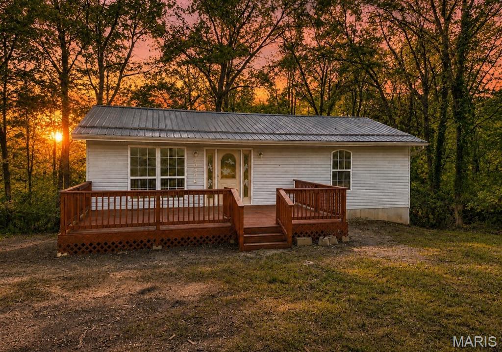 This 3 bedroom 3 bath home is nestled on 1.73 acres (6 lots) with access to Sunrise Lakes.  Have your own piece of quiet country living just a little over an hour from St. Louis just minutes off of Hwy 67.  Enjoy your morning coffee on the back deck and evening beverage on the front deck. The walk out basement leads you into a nice wooded area.  New Vinyl plank flooring has been installed, the lower level is completely finished and offers tons of natural light in the family room and bedroom, a bonus room has been finished for office, crafts or gaming. This home is in move in condition and the property has so much potential! Sellers have taken pride in ownership! Bring your preapproved buyers today...they could have their new private oasis by the holidays. Professional photos are coming this week.