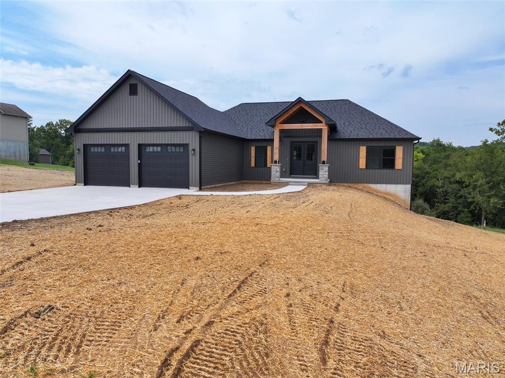 Located in Bloomsdale, Missouri, this new construction home offers three bedrooms, two full bathrooms, modern finishes, an unfinished walkout basement, and an attached two-car garage. The functional floor plan provides comfortable main-level living while the unfinished basement offers additional space for storage and the opportunity for future finishing. The kitchen is a central feature of the home and includes granite countertops that provide plenty of workspace for cooking and meal preparation. A center island adds additional counter space and creates a convenient area for seating, serving, or gathering. Brand-new appliances complete the kitchen and complement the clean, modern finishes throughout the home. The kitchen flows into the main living area, creating an open layout that makes efficient use of the space. Just off the living room is a deck that extends the living space outdoors. The deck provides a convenient location for outdoor seating, grilling, or simply spending time outside. Its direct connection to the living room makes it easily accessible from the main living areas of the home. The primary bedroom features a private full bathroom and a large walk-in closet. The primary bathroom includes a walk-in shower and a double-sink vanity, providing additional counter space and storage. The adjoining walk-in closet offers plenty of room for clothing and personal belongings while keeping everything conveniently located within the primary suite. Two additional bedrooms provide flexible space for a variety of needs, while a second full bathroom serves these bedrooms and the main living areas. The three-bedroom, two-bathroom layout provides an efficient use of the main level with the primary suite separated from the additional living spaces. One of the property's additional features is the unfinished walkout basement. The basement provides a substantial amount of additional space that can currently be used for storage, a workshop, or other purposes. With walkout access to the exterior, the basement also offers flexibility for future finishing based on the next owner's plans and needs, subject to applicable building requirements and approvals. An attached two-car garage provides covered parking along with additional room for tools, lawn equipment, and storage. Direct access between the garage and home adds convenience for everyday use. As a new construction property, the home features new finishes, fixtures, appliances, and building components throughout. The neutral interior provides a clean starting point for the next owner to furnish and personalize the home without first taking on the updates commonly associated with an older property. The Bloomsdale location provides convenient access to communities throughout Ste. Genevieve County and the surrounding region. Nearby roadways provide connections to Ste. Genevieve, Festus, and other communities for shopping, dining, services, and other amenities. For buyers searching for new construction in Ste. Genevieve County, this three-bedroom, two-bath home offers modern finishes, new appliances, an outdoor deck, an attached two-car garage, and an unfinished walkout basement with additional space for future plans.