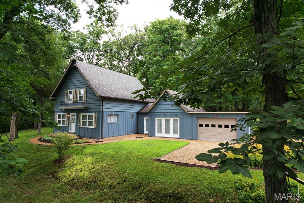 Tucked inside the gated community of Pinnacle Lake Estates, this 4 bedroom, 1.5 bath story and a half home offers a peaceful park like setting with plenty of space to enjoy lake community living. Step inside to a spacious living room featuring vaulted ceilings, an open staircase, balcony overlook, beautiful hardwood floors, and a pellet stove that creates a warm and inviting atmosphere during the cooler months.

The open layout continues into the dining area, which walks out to a charming garden area and connects seamlessly to the kitchen with a convenient breakfast bar. A large bonus/family room provides flexible space for entertaining, a home office, game room, or whatever fits your lifestyle. The main level also offers two laundry options for added convenience. Outside, Pinnacle Lake Estates offers an array of amenities, including a swimming beach and dock, picnic areas, BBQ pits, pavilion, playground, bathhouse with restrooms and showers, and available boat slips. Additional lots are available for purchase, including a lakefront lot at an additional cost. With its spacious layout, peaceful setting, and access to the community's recreational amenities, this property is ready to be enjoyed.