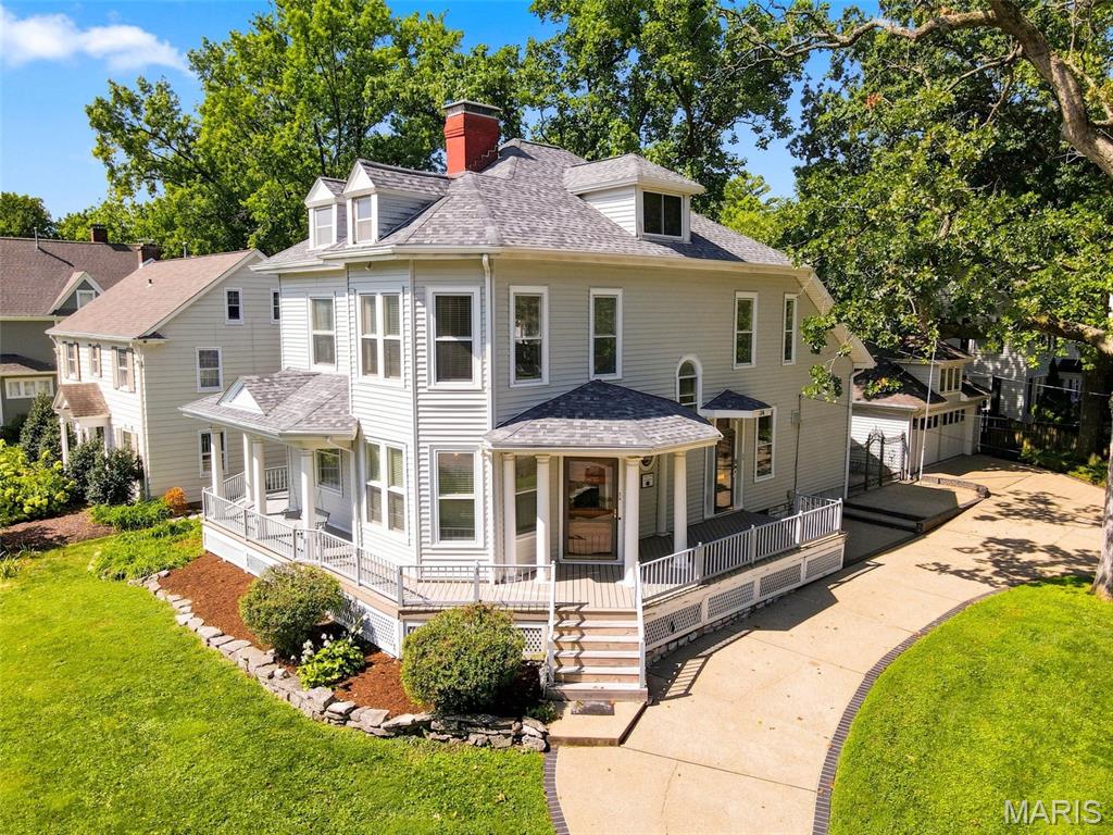 **Grand, historic and full of possibility in the heart of Webster Groves.** Built in 1893 and owned by the same family since the mid 1970s, this 5-bedroom, 3-full-bath home offers more than 3,400 square feet across three stories, plus the kind of architecture and scale that make old Webster homes so special. Even the wrap-around porch with the requisite porch swing will make you swoon.  

The dramatic staircase, tall ceilings, and original hardwood floors bring the character. The first floor features an entry foyer with decorative fireplace and grand staircase, a drawing room with bow window, living room with W/B fireplace and very generous dining room.  The huge country-style kitchen is the heart of this home for a family who loved to entertain BIG.  Loads of oak cabinetry, Dacor 6-burner range w/warming drawer and double wall ovens.   A 2005 addition on the west side expanded the original kitchen footprint to create a 20x20 space for a center island w/prep sink, walk-in pantry, bookshelves and 1/2 bath.  

Upstairs you'll find the primary bedroom with walk-in closet, laundry room, luxury bath with tub and separate shower (which was created in 2005 above the new kitchen). The first- and second-floor bathrooms were also gutted and rebuilt with updated plumbing and electrical. 2 more bedrooms and a full bath with double sinks complete the second floor.  The third floor features 2 attic style bedrooms with plenty of windows.  

Outside, nearly half an acre gives you a stately front lawn and still has an ample rear fenced yard for kids or pets.  The oversized 2-car carriage-style garage (24 wide x 21) includes a separate 240 SF workshop with its own electrical panel. The garage with ONE overhead door (made to look like double doors) was constructed in 2005. 

And the location is pure Webster: walkable to Webster Groves High School, Webster University, retail boutiques, cafes and restaurants in Downtown Webster, and about a mile to the recreation complex, pool, ice arena, tennis and Hixson Middle School.

This home needs restoration in each room: plaster repair, hardwood refinishing and cosmetic work—but the bones, size, setting and location are all here. Major systems have already been modernized with PVC, copper plumbing, Romex wiring and two 200-amp breaker panels, plus 2-100 amp sub-panels.  Updated Zoned HVAC keeps each level comfortable. Upstairs HVAC just 3 years old.  Roof replaced 2025.