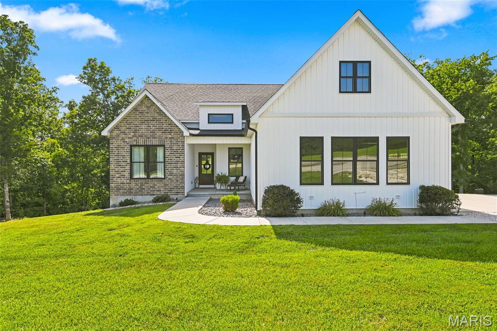 Tucked away at the end of a quiet cul-de-sac on nearly four wooded acres, this exceptional custom-built ranch offers the rare opportunity to enjoy the peace of country living without sacrificing modern comfort. Built in 2023, every detail reflects thoughtful design, quality craftsmanship, and timeless style. Step inside to soaring 10-foot ceilings, abundant natural light, and an open-concept floor plan that feels both spacious and inviting. The beautifully appointed kitchen is the heart of the home, featuring a large center island, stainless steel appliances, generous cabinetry, and seamless flow into the dining and great room perfect for everything from quiet mornings to holiday gatherings. The private primary suite is designed as a true retreat with a luxurious spa-inspired bath, oversized custom walk-in closet, and convenient access to the main-floor laundry. A split-bedroom floor plan provides privacy for family and guests, while the dedicated office offers the perfect work-from-home space. Step outside to the covered composite deck and enjoy peaceful views of the surrounding nature with mature trees, where wildlife and changing seasons become part of your everyday scenery. The walk-out lower level with a 9-foot pour and bath rough-in is ready for your vision, whether it's a recreation room, additional bedrooms, home gym, or all of the above. If you've been searching for the perfect combination of nearly new construction, premium finishes, privacy, and acreage, this home delivers. Enjoy the serenity of country living with the convenience of shopping, restaurants, schools, and Highway 61 just minutes away. This isn't simply a home, it is a lifestyle you'll look forward to coming home to every day.