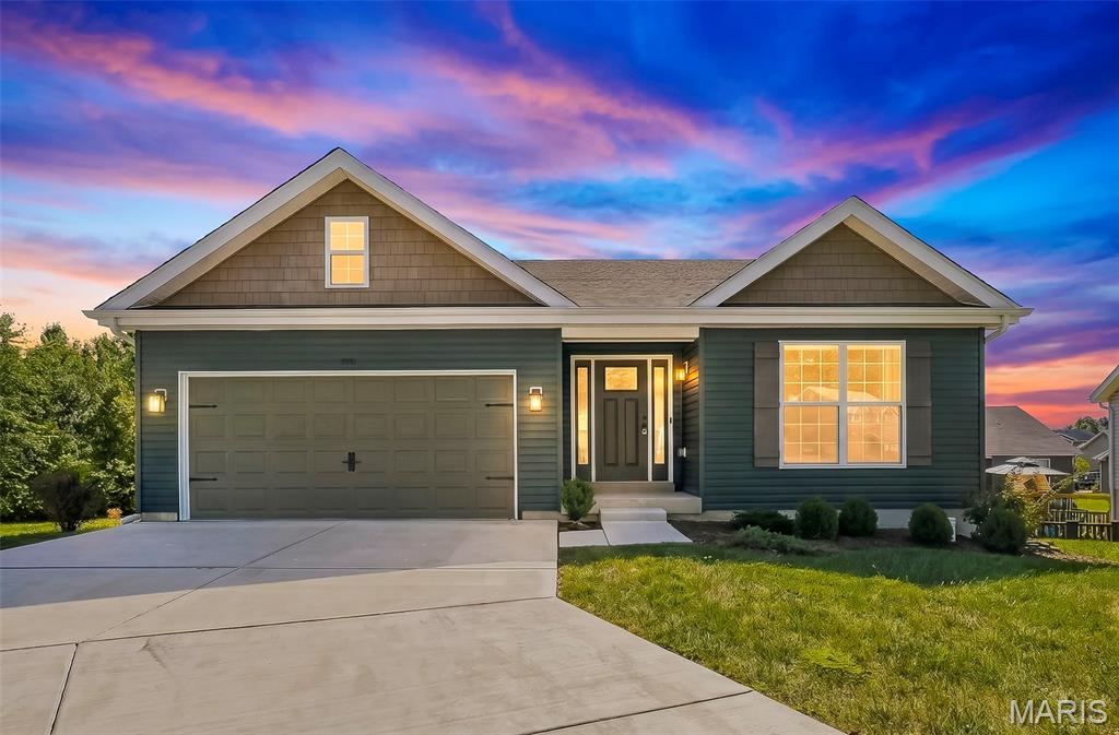 Only 2 years young with over $110,000 in builder and post-construction upgrades plus a new deck with a covered patio below, this 3 bedroom, 2 bath ranch is one you’ll want to see. Tucked on a quiet cul-de-sac in The Villages at Westlake, this home is gorgeous from the moment you walk in, with a magazine worthy look and so many beautiful details throughout. The open main living area feels bright and spacious with vaulted ceilings, oversized windows and LVP flooring throughout. The kitchen makes a statement with 42 inch soft close cabinetry with crown molding, quartz countertops, a large quartz island with seating, walk in pantry, under cabinet lighting, Bosch dishwasher and gas range with double ovens. You’ll find even more details throughout, including additional recessed lighting, outlets inside select cabinets, beautiful light fixtures, updated faucets and bathroom vanities, upgraded hardware and enhanced closet storage. A wood staircase with metal spindles adds another custom touch, while the office offers custom built ins and the laundry room has built in storage and a bench to help keep everything organized. The split bedroom floor plan gives the primary suite added privacy with two closets, including a walk in, and a private bath with dual sinks and a walk in shower. The full unfinished walkout basement gives you a great start for future living space with a 9 foot pour, multiple windows, sliding glass door, bathroom rough in and additional electrical already in place. Outside, the new deck and covered patio below give you two separate areas to enjoy the backyard. The generous lot offers plenty of room to spread out, with newly planted trees that will continue to add privacy as they mature. Even the garage received extra attention with an upgraded garage door, added lighting and a workbench. The neighborhood also offers a lake with fishing access, a pool and playground, plus easy access to I-44, shopping, dining, schools and parks. So much has already been done here, and the details are even better in person. Make sure this one is on your list to see!