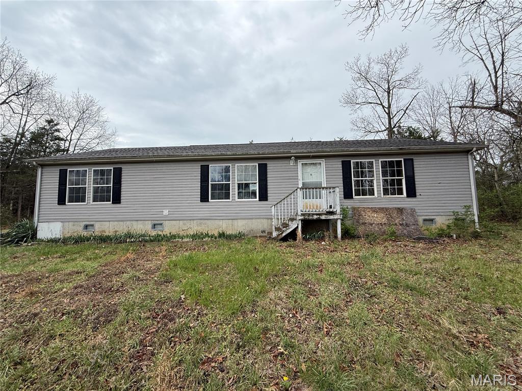 Investor or sweat-equity opportunity! This 3 bed, 2 bath manufactured home sits on 1.9 acres just outside of town, set back from the road for privacy, serenity, and a true country feel, while still only minutes from local amenities. Inside, 1,860 sqft of strong, well-built living space includes a large kitchen with abundant cabinet space—just minor aesthetic updates needed to make it move-in ready. Outside, a massive 25x30 outbuilding with electric, single and double garage doors, and over 700 sqft of versatile space offers endless possibilities and provides ample parking. A rare chance to add value in a peaceful setting! Schedule your showing now!