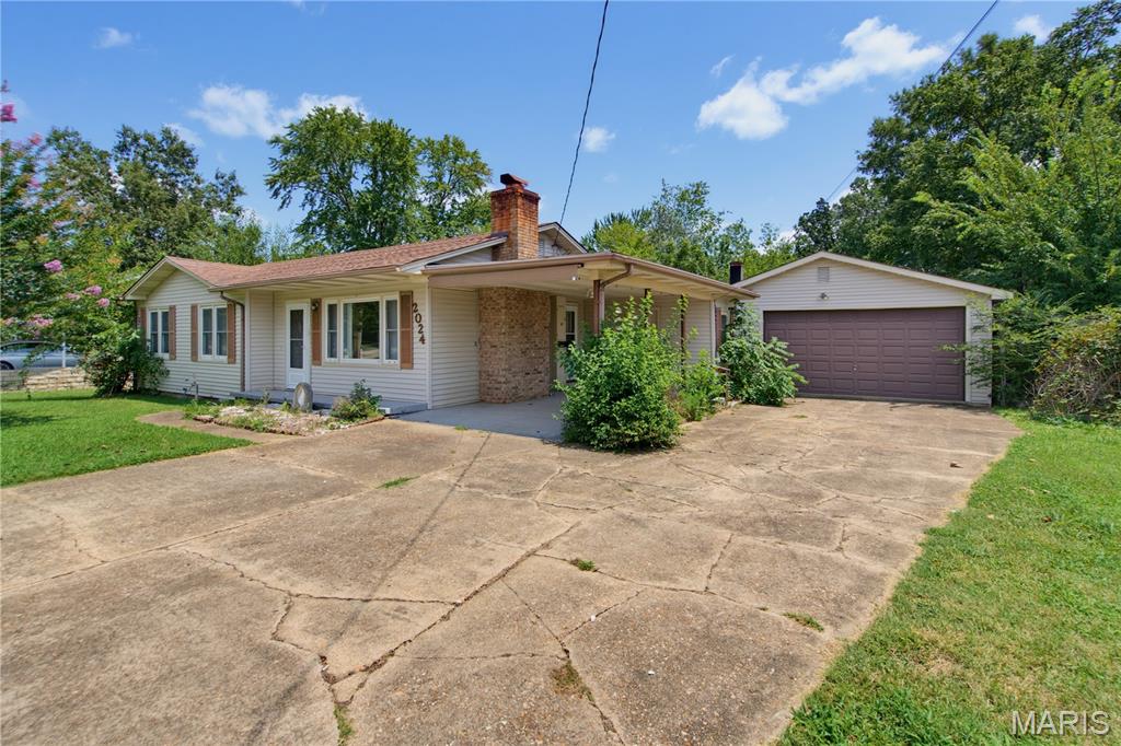 Welcome home to this charming 3-bedroom, 1-bathroom home with a detached two-car garage, attached carport and fenced back yard. This home has a traditional layout you'll love. Enjoy cozy evenings by the wood-burning fireplace in the living room while the kitchen and dining area provide an open functional space. The laundry room has plenty of shelving making it perfect for pantry items and extra storage. Outside, you'll have plenty of space to enjoy with a covered front porch, a chain-link fenced backyard and concrete patio area, two garden spigots and a durable storage shed. Parking is a breeze with the attached carport and detached oversized two-car garage. Located in the northern part of Poplar Bluff city limits, in the O'Neal School District, only a short distance to parks, shopping, restaurants, churches and hospitals. This home has comfort, storage, outdoor space and an affordable price. Property is being sold in it's current condition. 2024 N 14th Street, Poplar Bluff, $139,900. Schedule your private tour today!