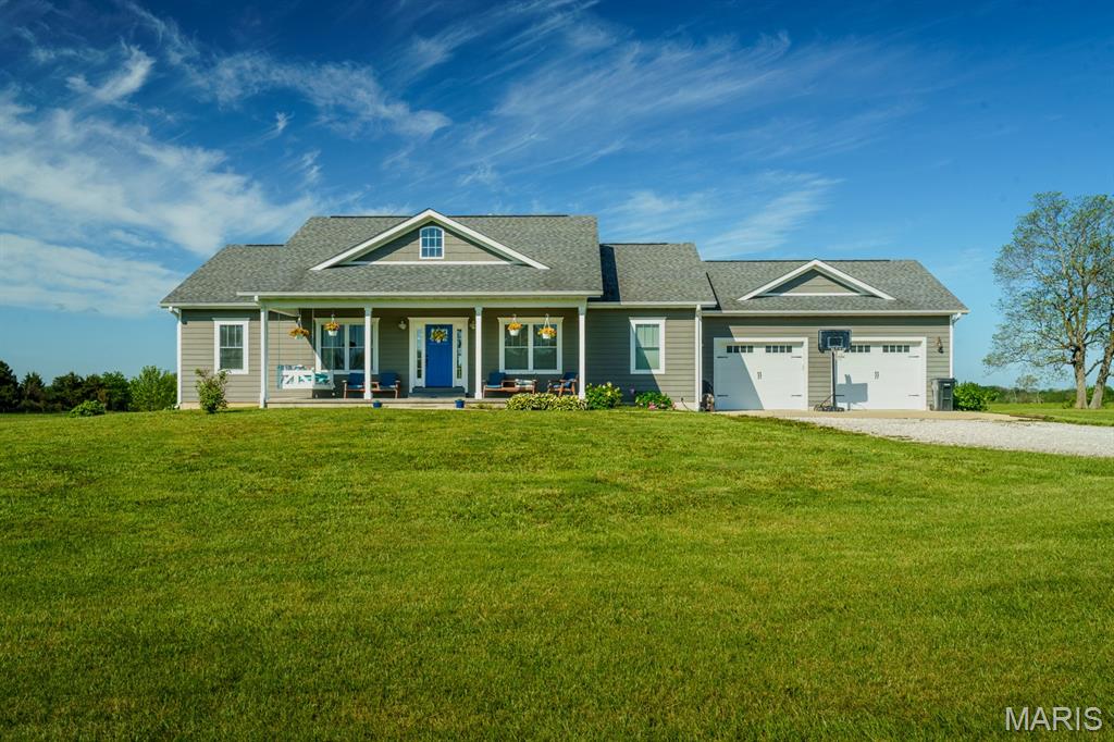 THE PLACE YOU WOULD LOVE TO COME HOME TO! This could be your family's sanctuary away from it all on 9+ picturesque acres south of Rolla and just north of Licking. Custom-built home perfectly placed sitting back from the road behind a stand of tall pines but just minutes from the conveniences in town. The welcoming covered porch leads to a spacious open-concept living, kitchen, and dining area filled with natural light, creating a warm and inviting atmosphere while the sleeping areas offer split bedroom design. The living room includes a gas log fireplace and built-in cabinetry and opens to a kitchen truly designed to be the heart of the home including custom-built soft-close cabinetry with under cabinet lighting, raised tile backsplash, stainless farmhouse sink, a 5 burner gas range, stainless hood, baking drawers and a spacious island to provide functionality and the perfect spot to gather.  Entertaining can easily spill over to the covered patio where you will enjoy a panoramic view including fruit and nut trees and the fenced garden area for growing your own produce with raised beds of established strawberries, asparagus, thornless blackberries and raspberries.  The main level includes a master suite with large walk-in closet, 2 more bedrooms, full bath, and a thoughtfully designed, expansive Laundry and Mud room offering a bench, shelving, wall hooks and a third bathroom, all to make the perfect drop zone for your family coming and going. There is a walk-in Pantry with barn door and the laundry area includes a utility sink, hanging space, a folding counter, shelves for laundry basket sorting, and storage cabinets to keep a busy household organized. The lower level offers a huge Family or Rec room plus the possibility of three more bedrooms (two have closets but no windows), or Office area, a large Storage room, another full bath and walks out to a 26' x 16' patio. The oversized garage provides space for toys, hobbies or extra storage besides your vehicles. This home offers ease of maintenance with Legacy SmartSide Engineered wood siding and wrapped fascias and soffits plus guttering. There is even a tree house tucked into the pines and space to have a horse so come experience the place you could truly call HOME!
