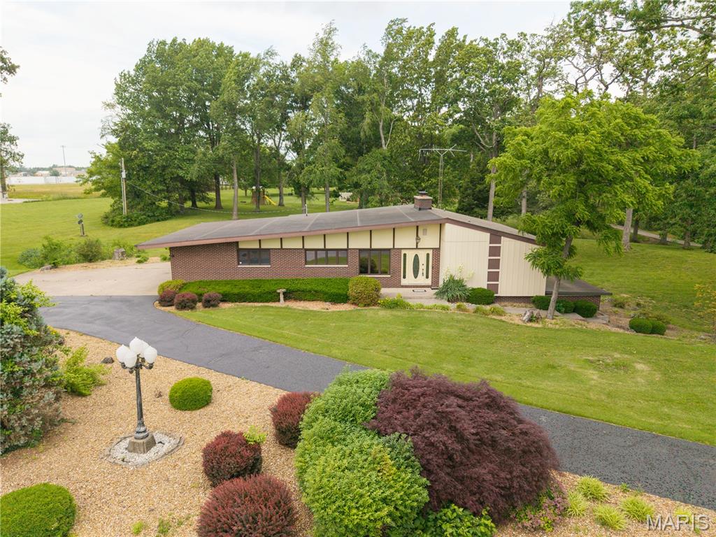 Everything you’ve been searching for! This spacious 3 bedroom, 3 bath home sits on approximately 4.6 acres just outside of city limits. Features the perfect blend of privacy and convenience. The generously sized rooms throughout the home make it ideal for entertaining. Recent updates include a beautifully remodeled kitchen featuring updated countertops and a tile backsplash. Take time to enjoy the peaceful surroundings from the screened porch with new screens. The finished basement offers a large family room complete with a wet-bar, a fireplace insert and a kitchenette. This property is truly a park like setting.
