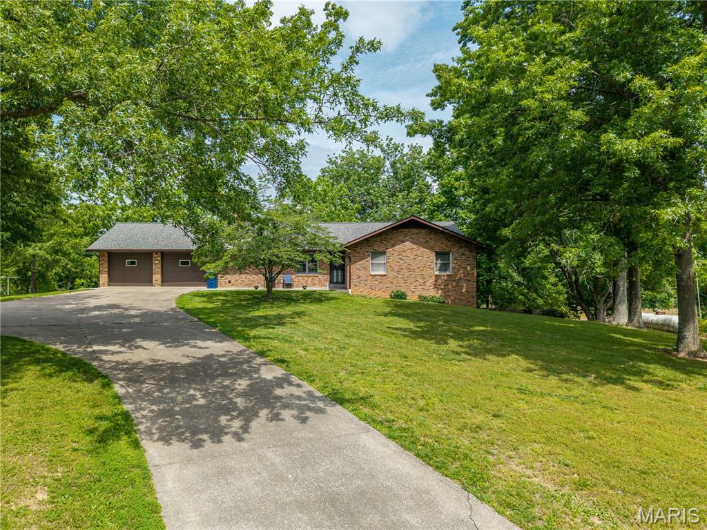 Located just outside the city limits of Perryville, sits this full-brick ranch home on 4.34 acres. You will fall in love with the vaulted ceilings, conveniently located main-level laundry, and remodeled bathrooms. Featuring three spacious bedrooms, four bathrooms, and 2,800 +/- square feet of finished living space, this home offers plenty of room for you and your family to spread out.
The walk-out basement includes an additional family room, partial kitchen, wood-burning fireplace, and a full concrete John Deere room. If you are looking for a move-in-ready home close to the amenities of Perryville, with plenty of space for your family to enjoy the outdoors, then this home checks all the boxes