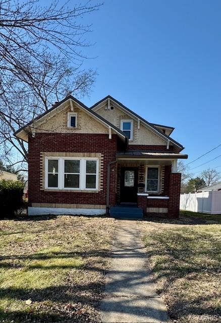 This charming, historic brick home is conveniently located in the heart of Washington. Step inside where the immaculate hardwood floors and sunlight coming in all of the windows make the home feel warm and inviting. A large living room with a wood-burning fireplace as well as the spacious dining room will be areas many family memories will be made.  Some old charm is featured in the stained glass windows, nooks and built ins you'll find in different areas of the home. There are  three bedrooms, one on the main level and two upstairs. Two full bathrooms, one on each level, offers convenience for everyone. The walkout basement is convenient to the fenced backyard and alley parking plus has a brand new sump pump/pit.  With convenient parking options, alley or street,  and a unique blend of history and modern upgrades, this home is a wonderful opportunity for those seeking a character-filled home.  Or seeking a move-in ready older home with charm.