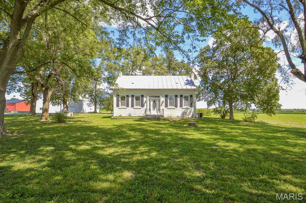 Price listed is Starting Bid Only. Bidding starts closing 8/12/2026 @ 5 p.m.Experience the charm of country living while remaining just minutes from town with this 3BR/1BA farmhouse situated on a recently surveyed 10± acre parcel in Waterloo, IL. Surrounded by open space and offering plenty of room to spread out, this property combines rural tranquility with convenient access to everyday amenities. The newly surveyed acreage includes a portion of income-producing tillable farmland, providing additional value and potential for agricultural use or supplemental income. Farming rights for the tillable acreage will be available for the 2027 crop season, offering the new owner the opportunity to farm the ground or negotiate a cash rent agreement. The home features a spacious living room and two generously sized main-level bedrooms that share a full bathroom off the central hallway. The combined kitchen and dining area is enhanced by beautiful bay windows and anchored by a cozy wood-burning fireplace with a brick mantel, creating a warm and inviting gathering space. Upstairs, a comfortable third bedroom is accompanied by a bonus room that could serve as a fourth bedroom with a little TLC and finishing touches. The partial, unfinished basement provides space for the home’s utilities and includes washer and dryer hookups. A fully enclosed breezeway connects the home to the attached two-car garage, offering additional room for a workshop, hobby area, or extra storage. Outdoor improvements include a 28’ x 32’ barn with electricity available and an upper hay loft, as well as a 60’ x 60’ pole barn with electricity available featuring a poured concrete floor and three overhead garage doors for convenient equipment access. These versatile outbuildings offer excellent space for livestock, equipment storage, hobbies, workshops, or agricultural use. The property is served by public water, a propane tank that is owned by the seller, and a private aeration system for sewer service. Conveniently located within Waterloo Community Unit School District No. 5, this property is just minutes from IL Route 3 for an easy commute and close to the shopping, dining, and entertainment options of historic Downtown Waterloo. P.O.A. assisting Seller is related to the seller and is a Licensed IL Real Estate Agent. Property will sell under auction terms and be sold AS- IS, WHERE-IS. Seller, will not make any repairs as a result of any building, occupancy, or environmental inspections. Buyer will be required to sign an Auction Purchase & Sale Agreement if final bid is accepted by Sellers.